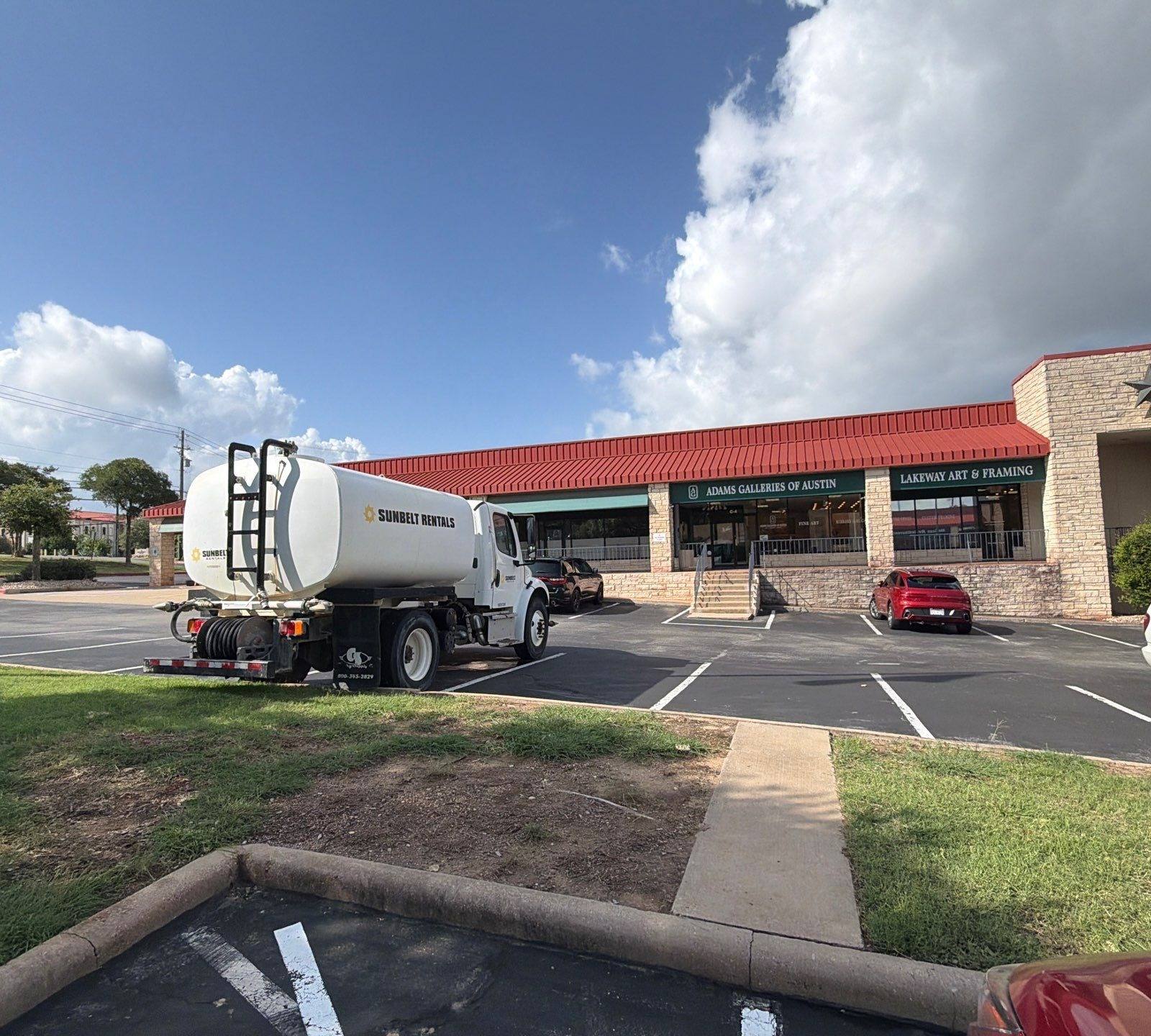 Storefront facade of a retail center on Ranch Rd 620 S in Lakeway, TX prepared for an exterior painting estimate by Hill Country Painting