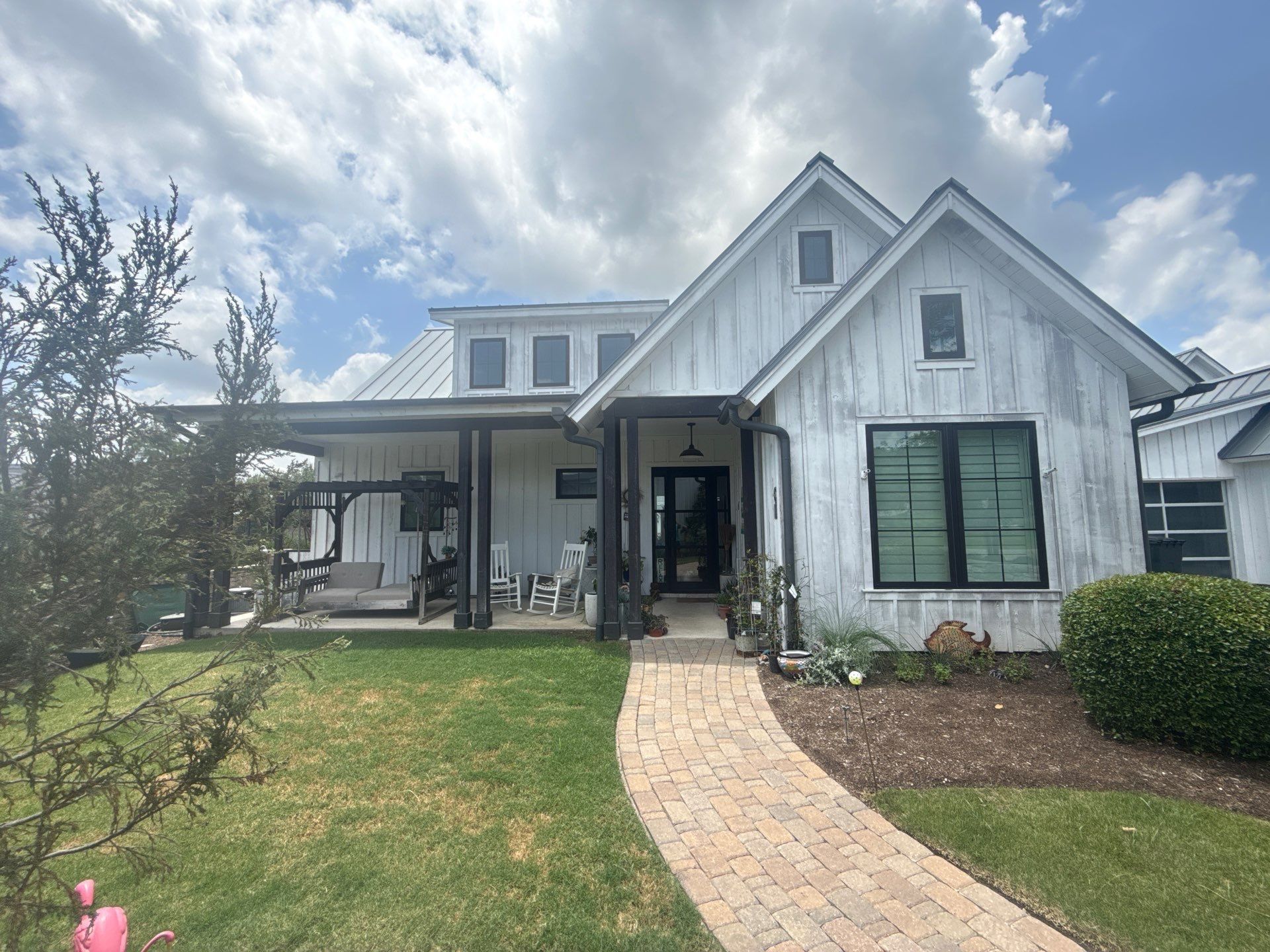 Front exterior of a home on Flying J Blvd in Spicewood, TX ahead of an exterior painting estimate by Hill Country Painting