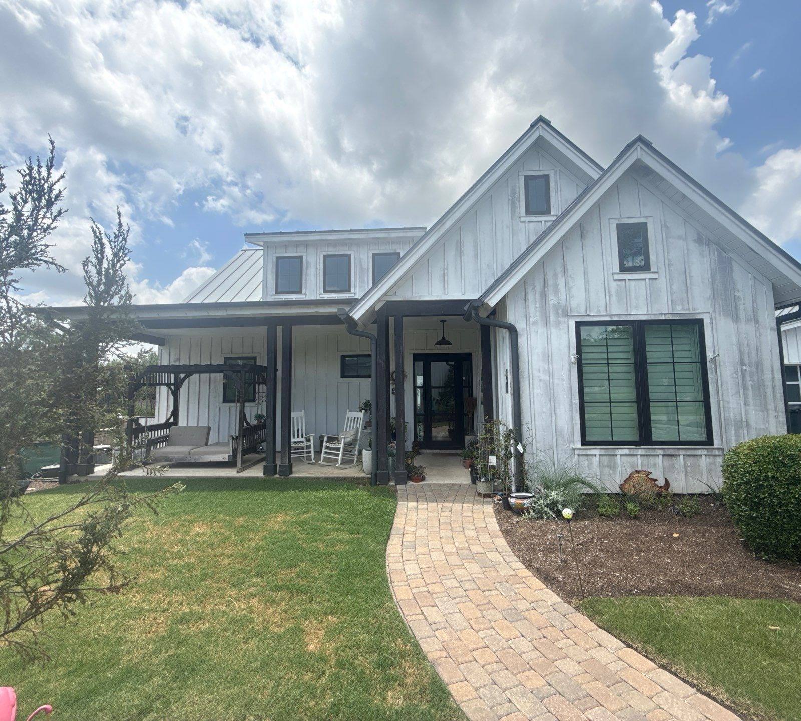 Front exterior of a home on Flying J Blvd in Spicewood, TX ahead of an exterior painting estimate by Hill Country Painting