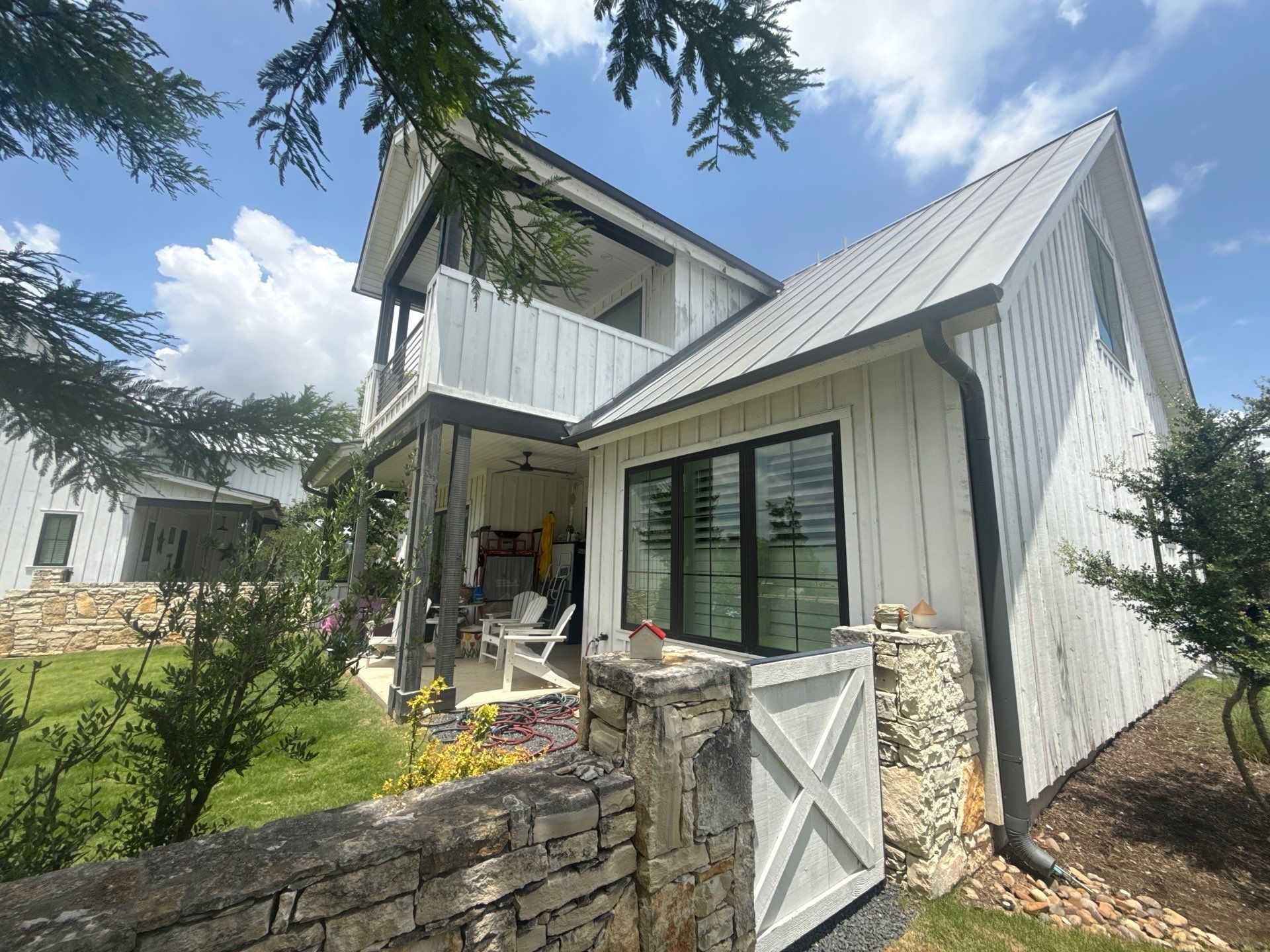 Side exterior of a home on Flying J Blvd in Spicewood, TX ahead of an exterior painting estimate by Hill Country Painting