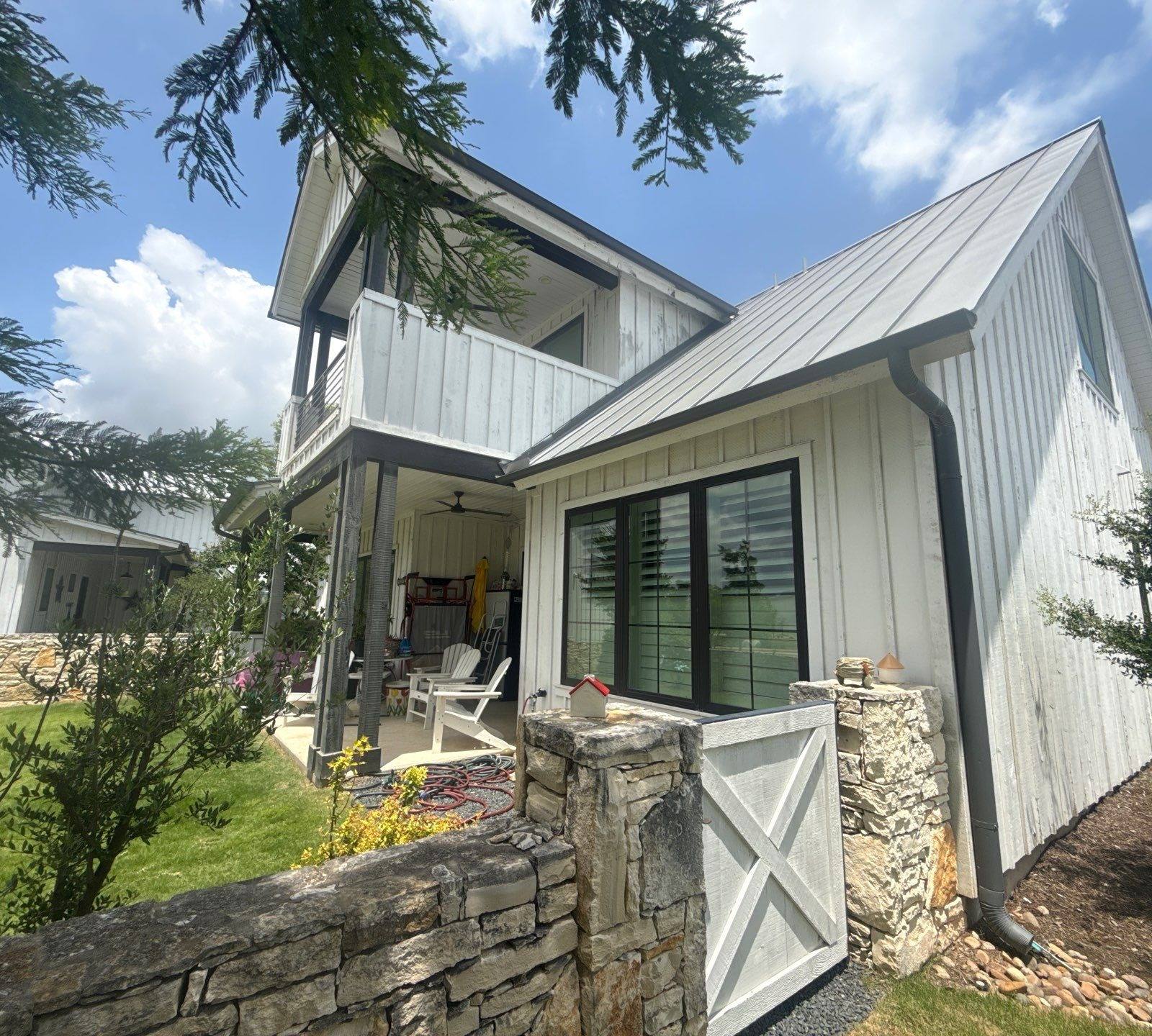 Side exterior of a home on Flying J Blvd in Spicewood, TX ahead of an exterior painting estimate by Hill Country Painting
