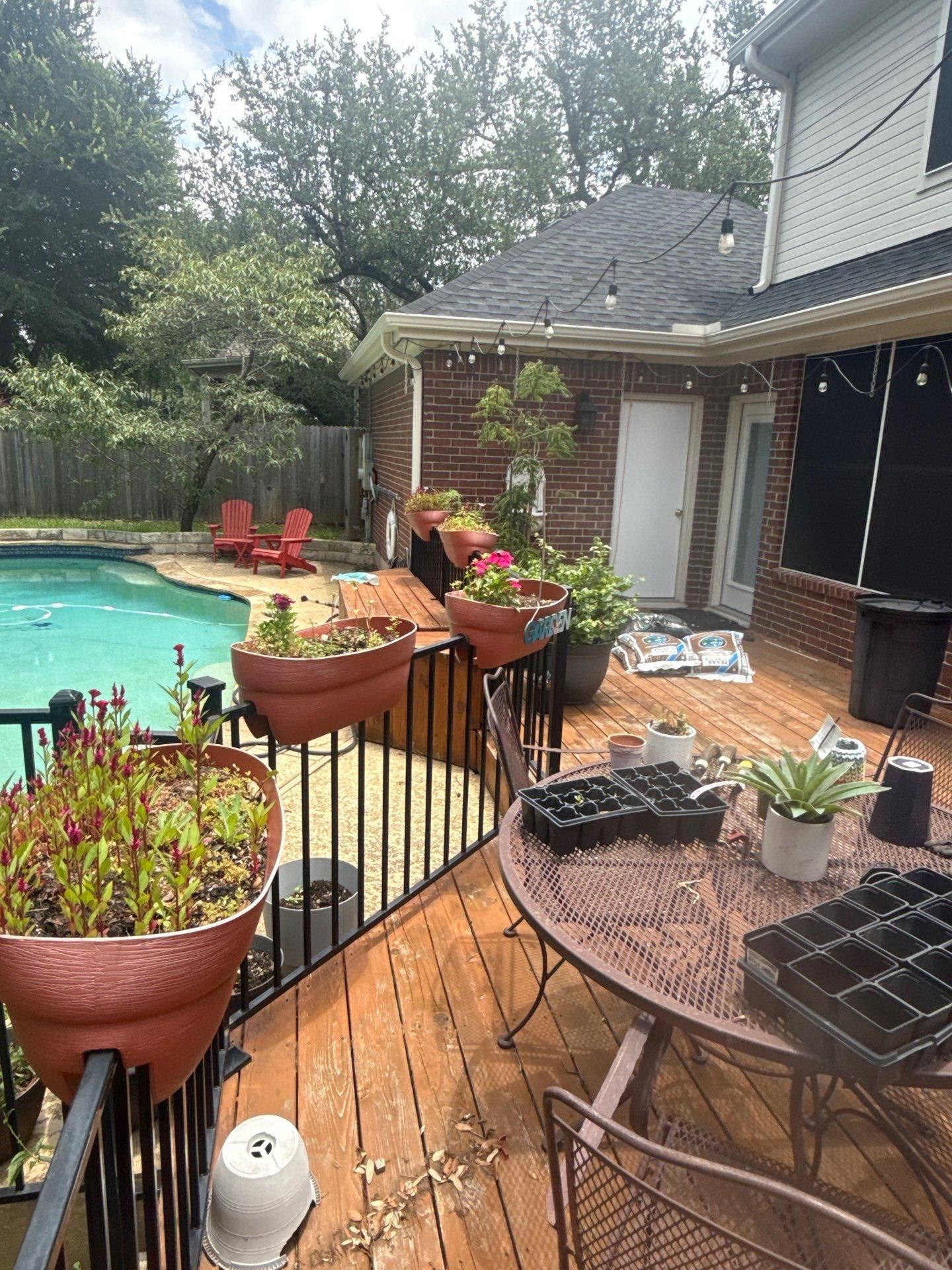 Back deck and pool area of a home on Blue Lilly Dr in Austin, TX ahead of exterior painting and deck staining by Hill Country Painting