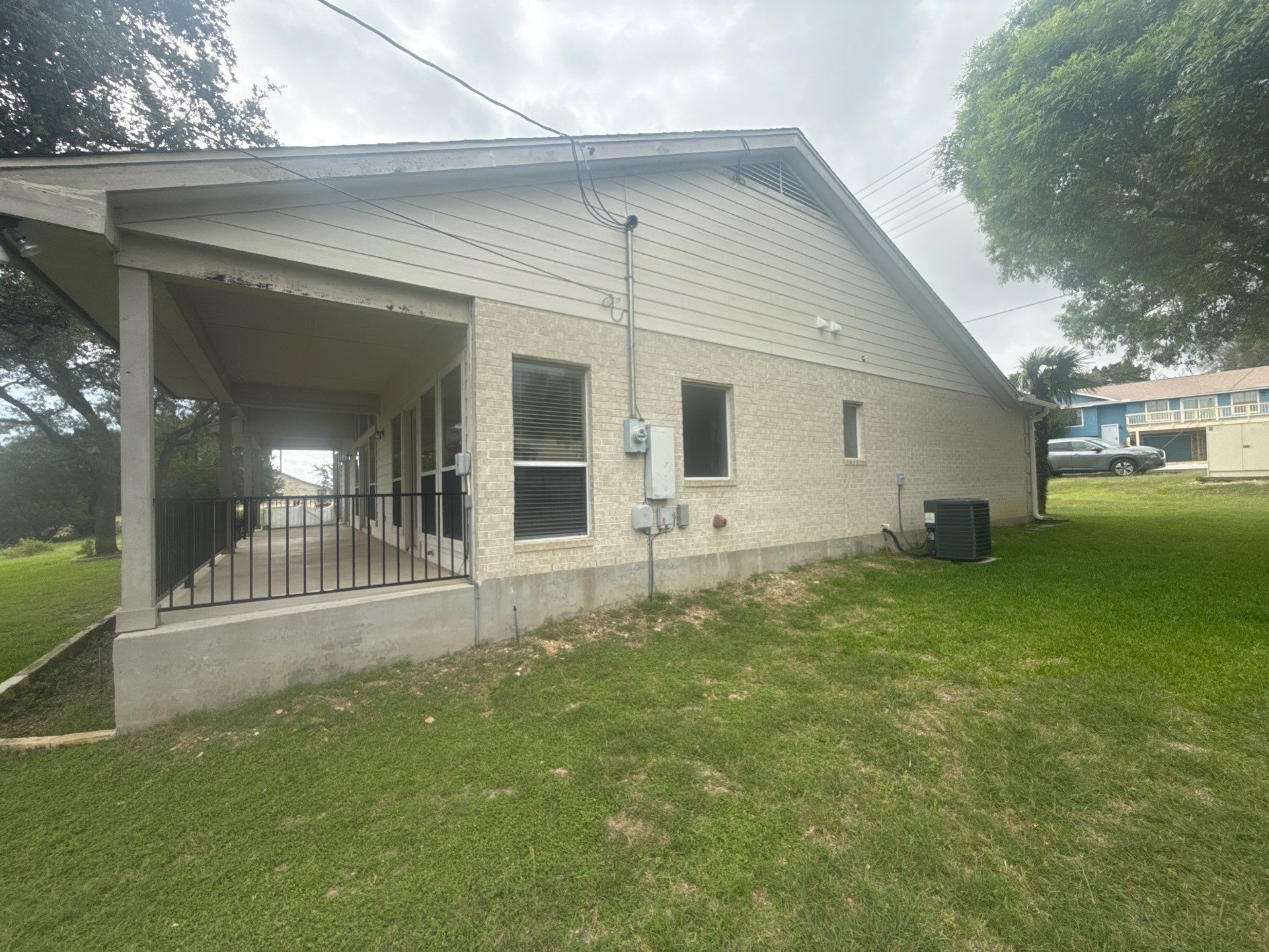 Side exterior of a home on Boggy Ford Rd in Lago Vista, TX ahead of exterior painting by Hill Country Painting
