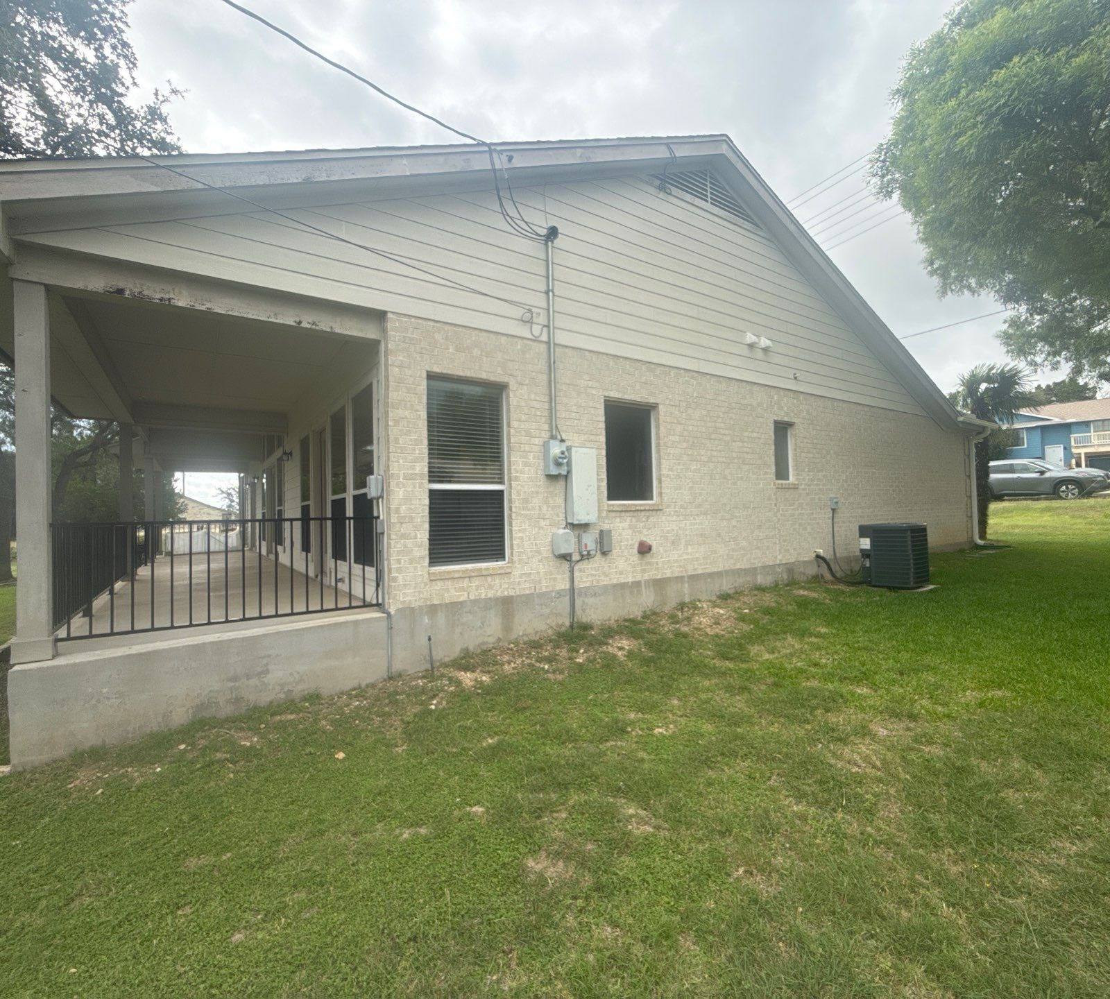 Side exterior of a home on Boggy Ford Rd in Lago Vista, TX ahead of exterior painting by Hill Country Painting