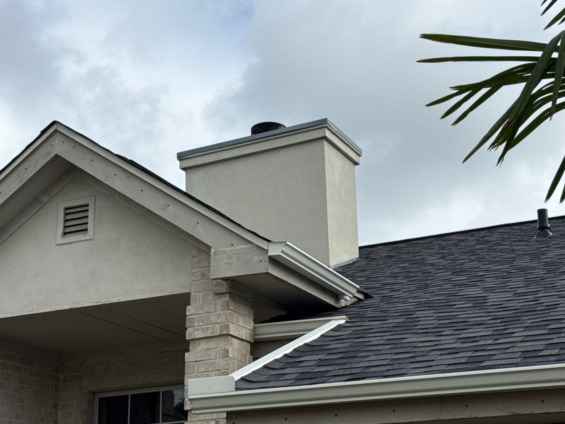 Chimney and roofline of a home on Boggy Ford Rd in Lago Vista, TX ahead of exterior painting by Hill Country Painting