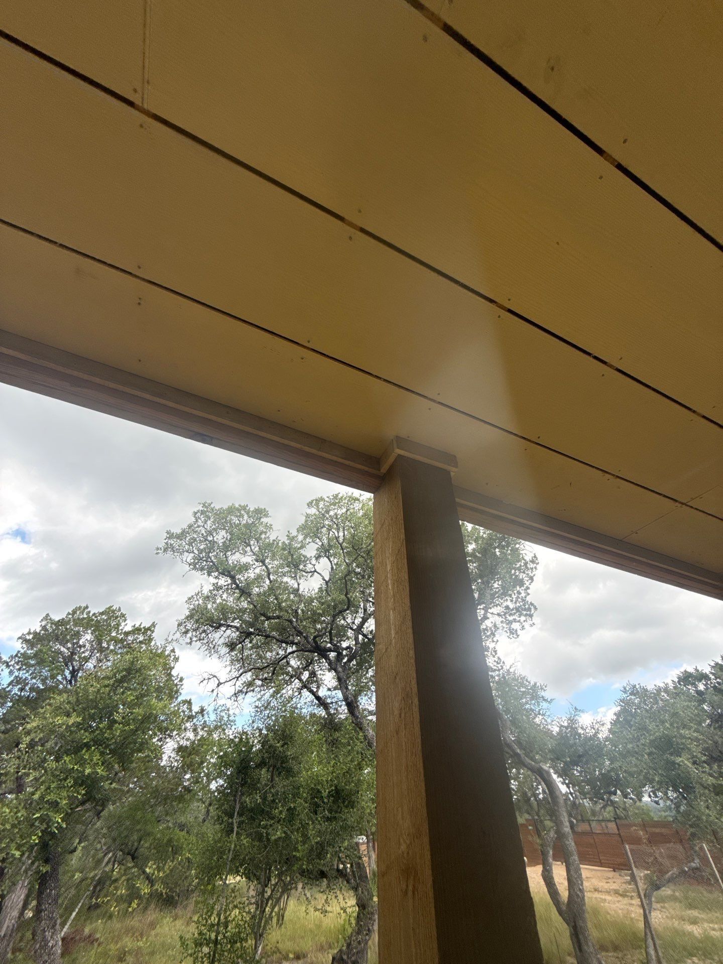 Porch ceiling and column of a home on W Beach Rd in Austin, TX ahead of exterior painting by Hill Country Painting