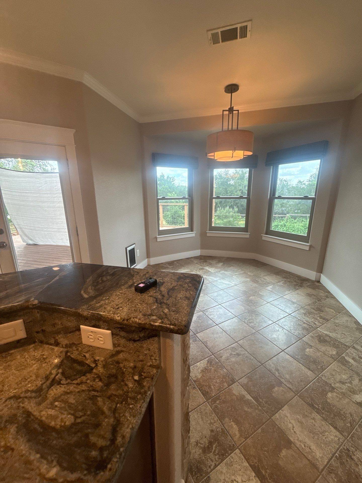 Breakfast room with bay windows of a home on Tucumcari Trail in Austin, TX ahead of interior painting by Hill Country Painting