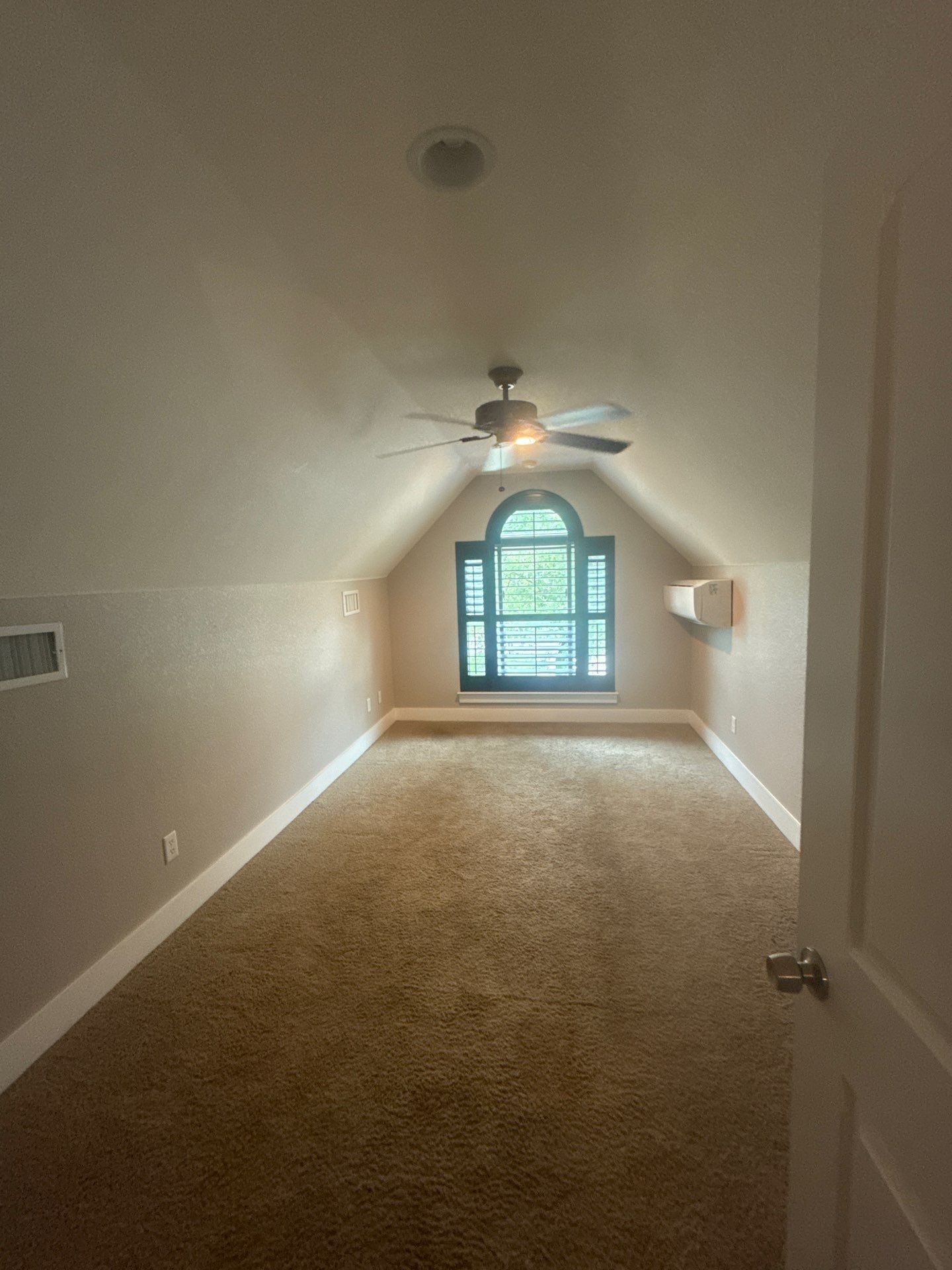 Vaulted bedroom with arched window of a home on Tucumcari Trail in Austin, TX ahead of interior painting by Hill Country Painting