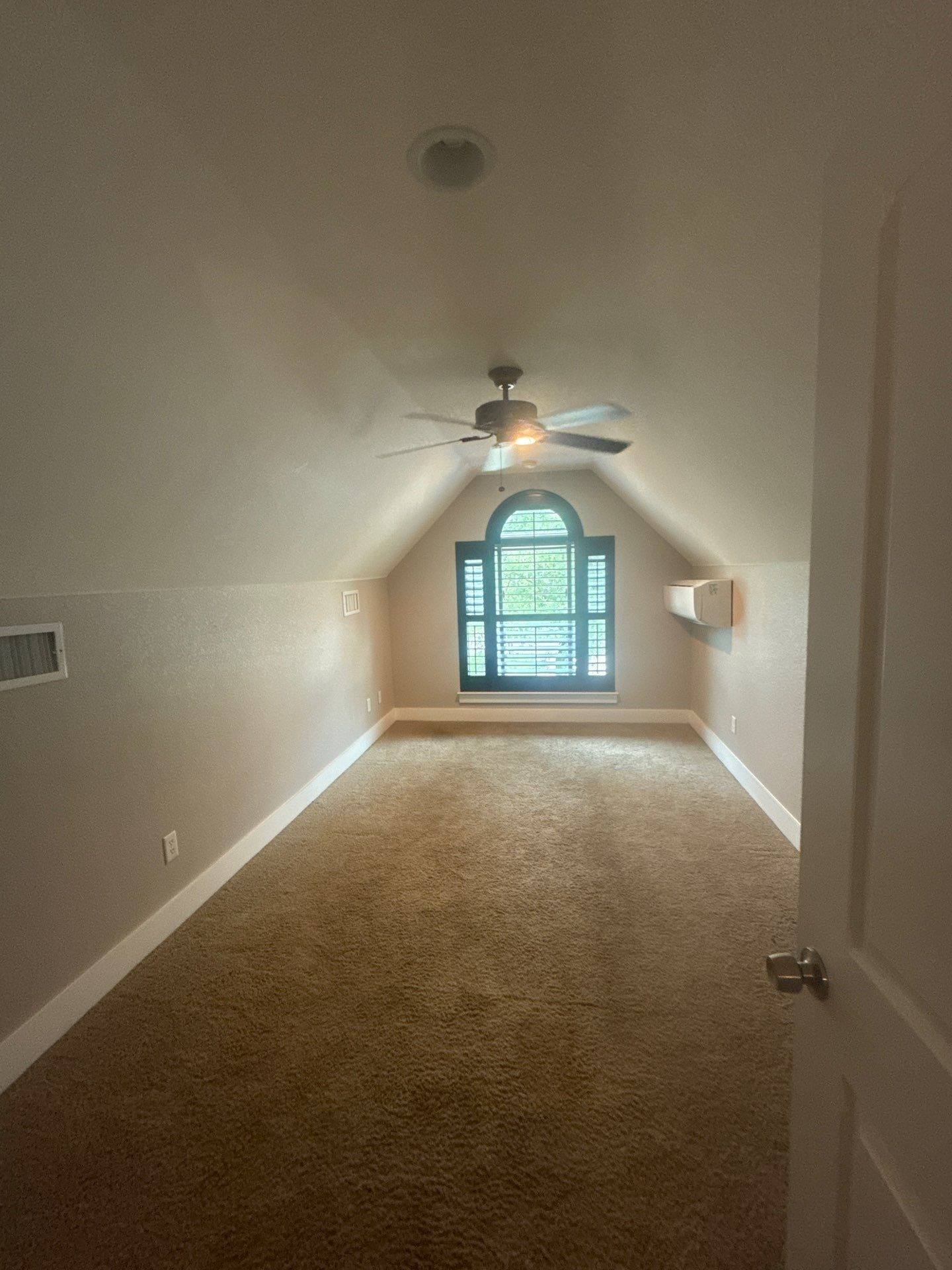 Vaulted bedroom with arched window of a home on Tucumcari Trail in Austin, TX ahead of interior painting by Hill Country Painting