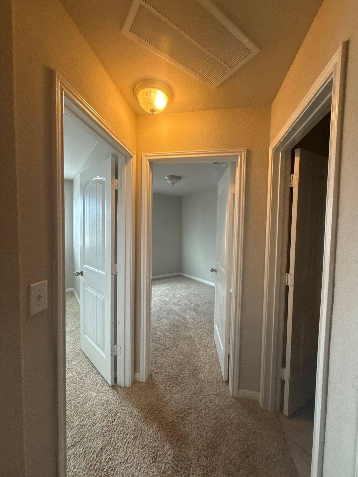 Hallway of a home on Adage Dr in Pflugerville, TX ahead of interior painting by Hill Country Painting