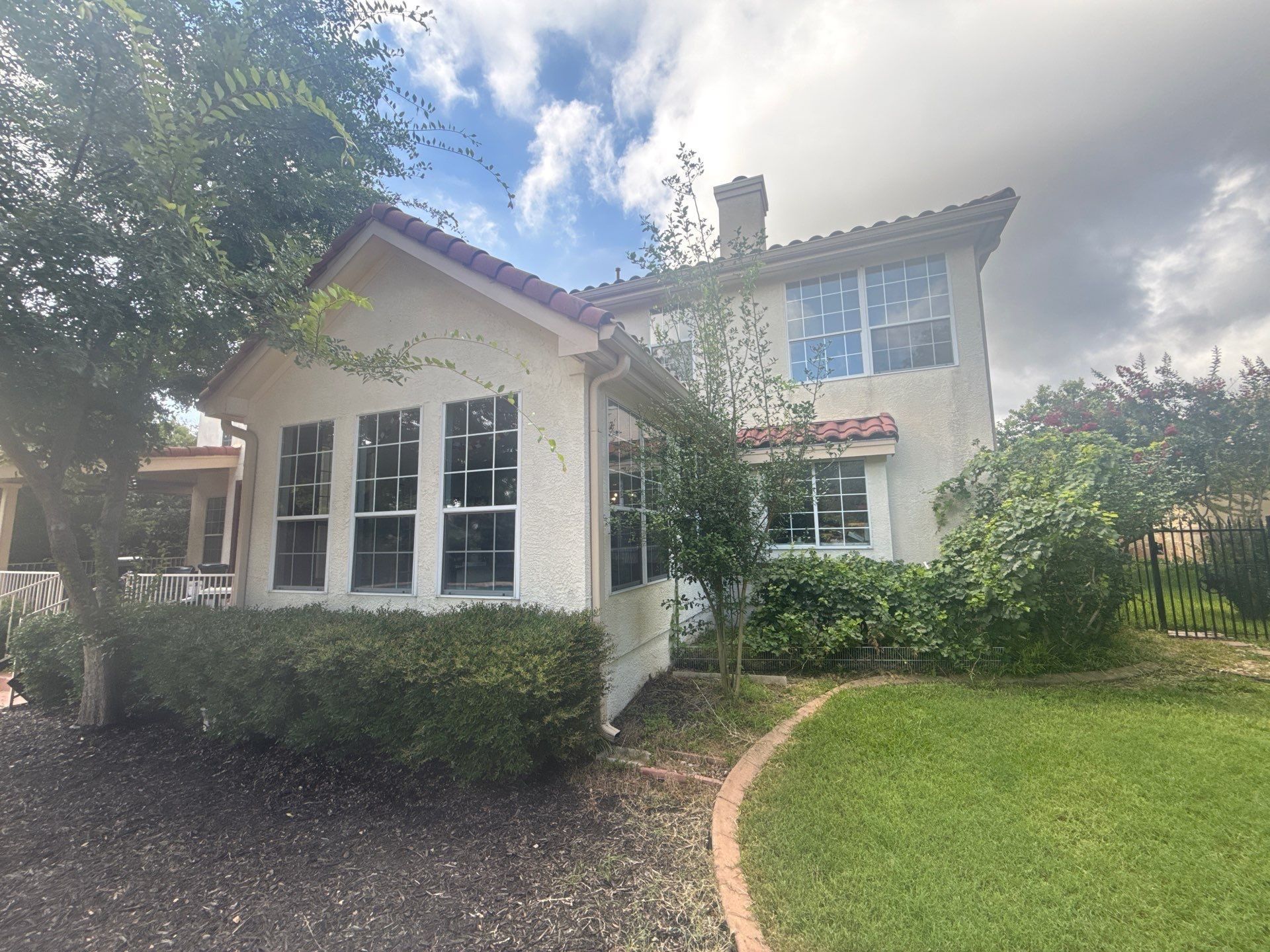 Back exterior and roofline of a home on Wingreen Loop in The Hills, TX ahead of exterior painting by Hill Country Painting