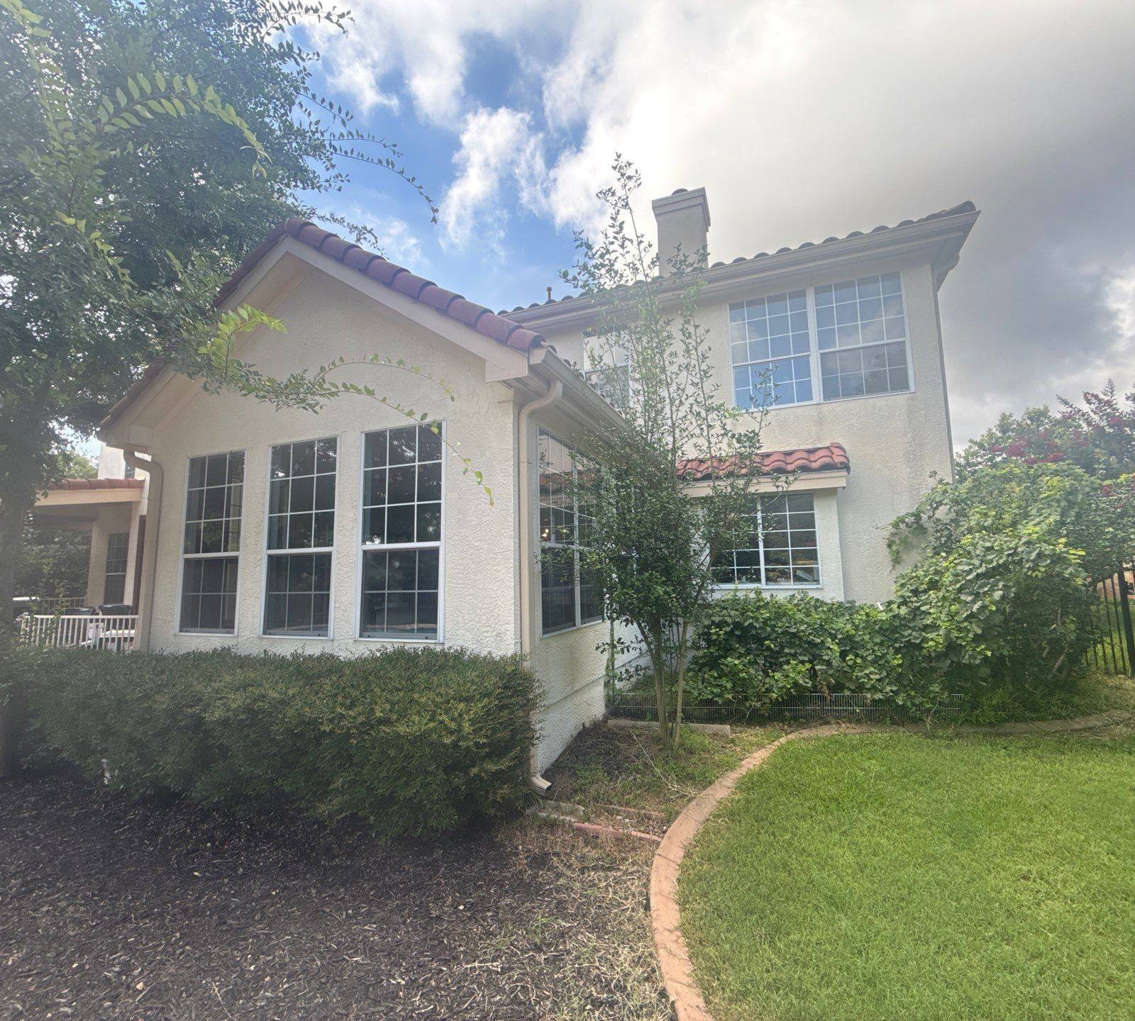 Back exterior and roofline of a home on Wingreen Loop in The Hills, TX ahead of exterior painting by Hill Country Painting