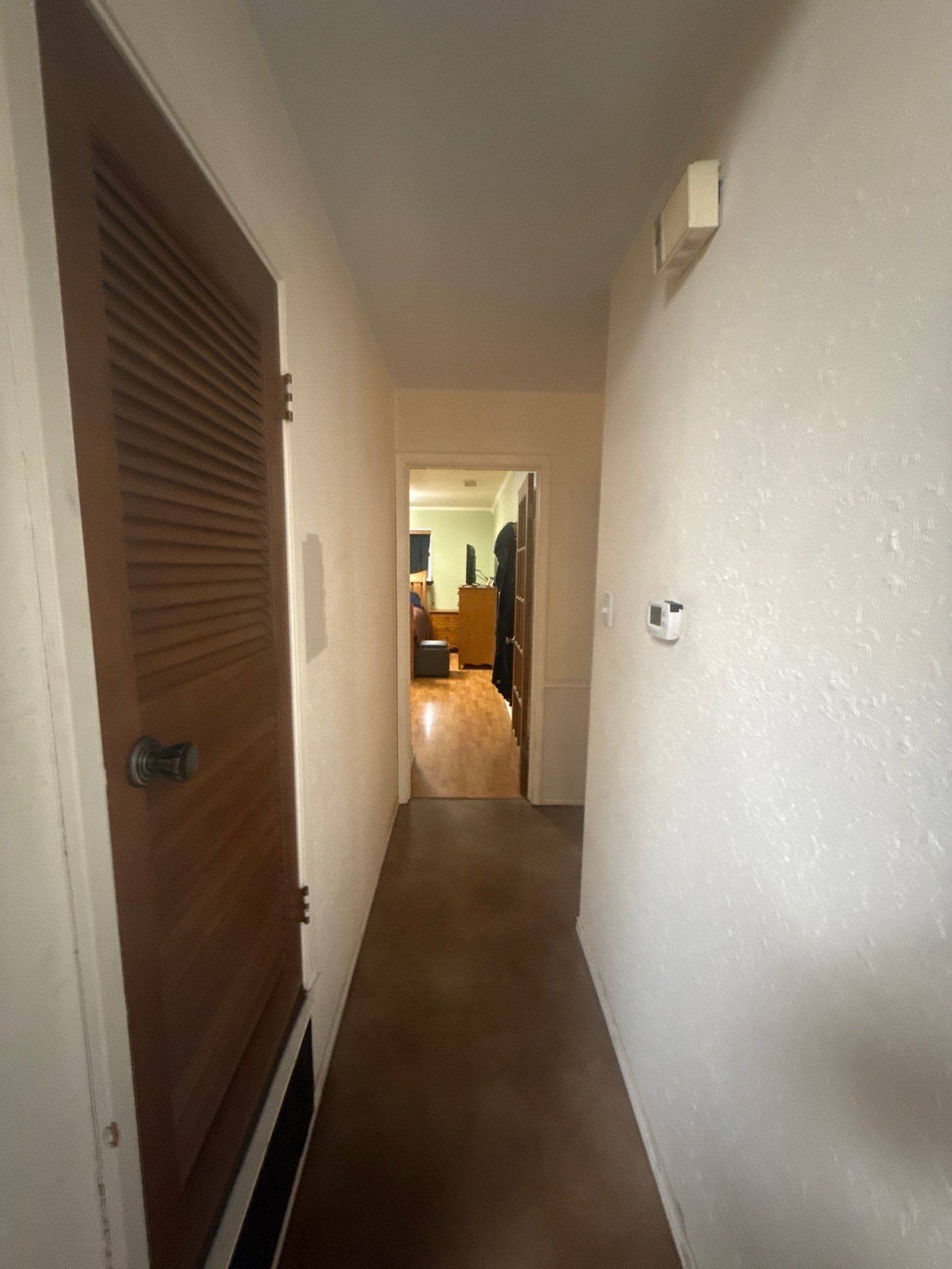 Hallway of a home on Hornsby St in Austin, TX ahead of interior painting by Hill Country Painting