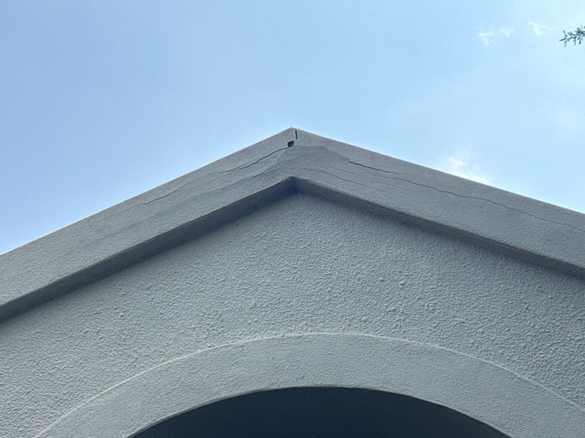 Stucco gable detail of a home on Tellus St in Lakeway, TX ahead of exterior painting by Hill Country Painting