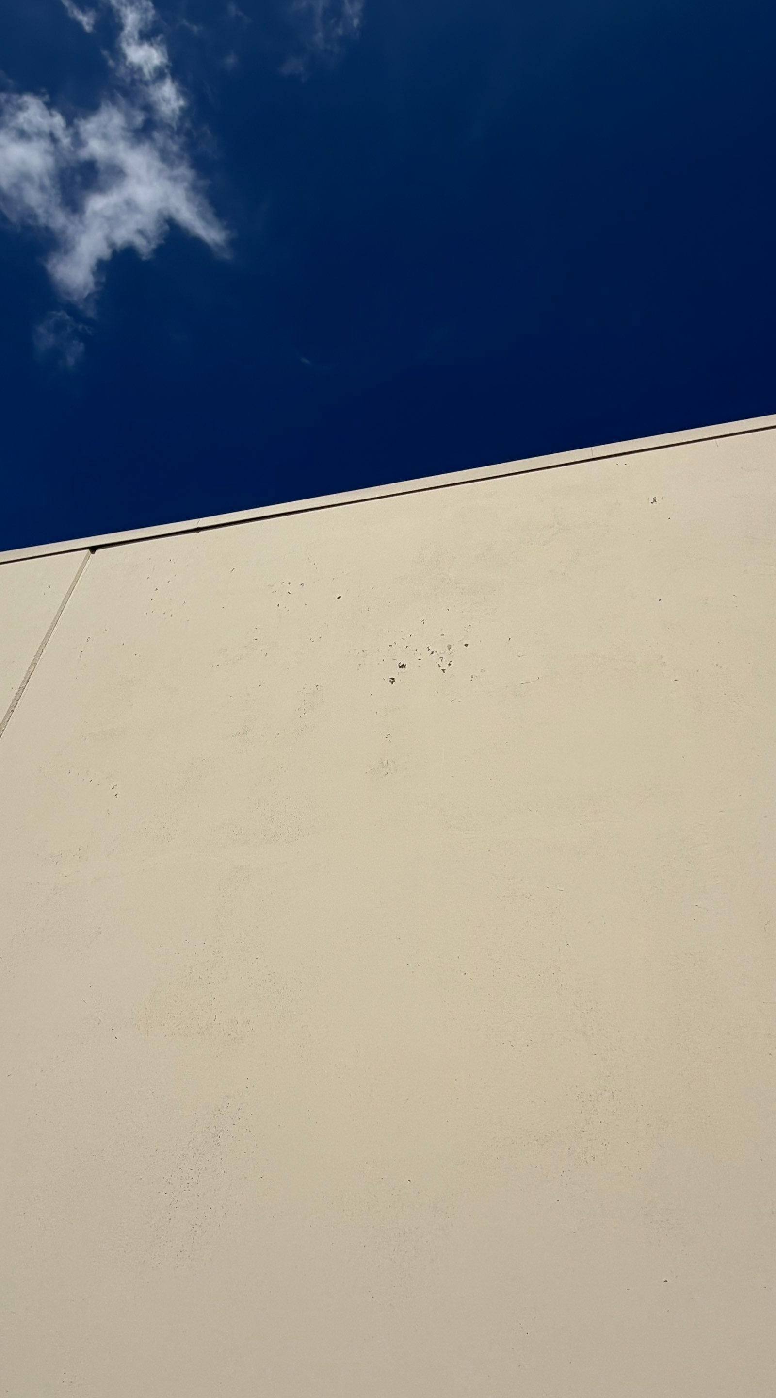 Exterior wall surface of a commercial building on Highway 79 in Hutto, TX ahead of exterior painting by Hill Country Painting