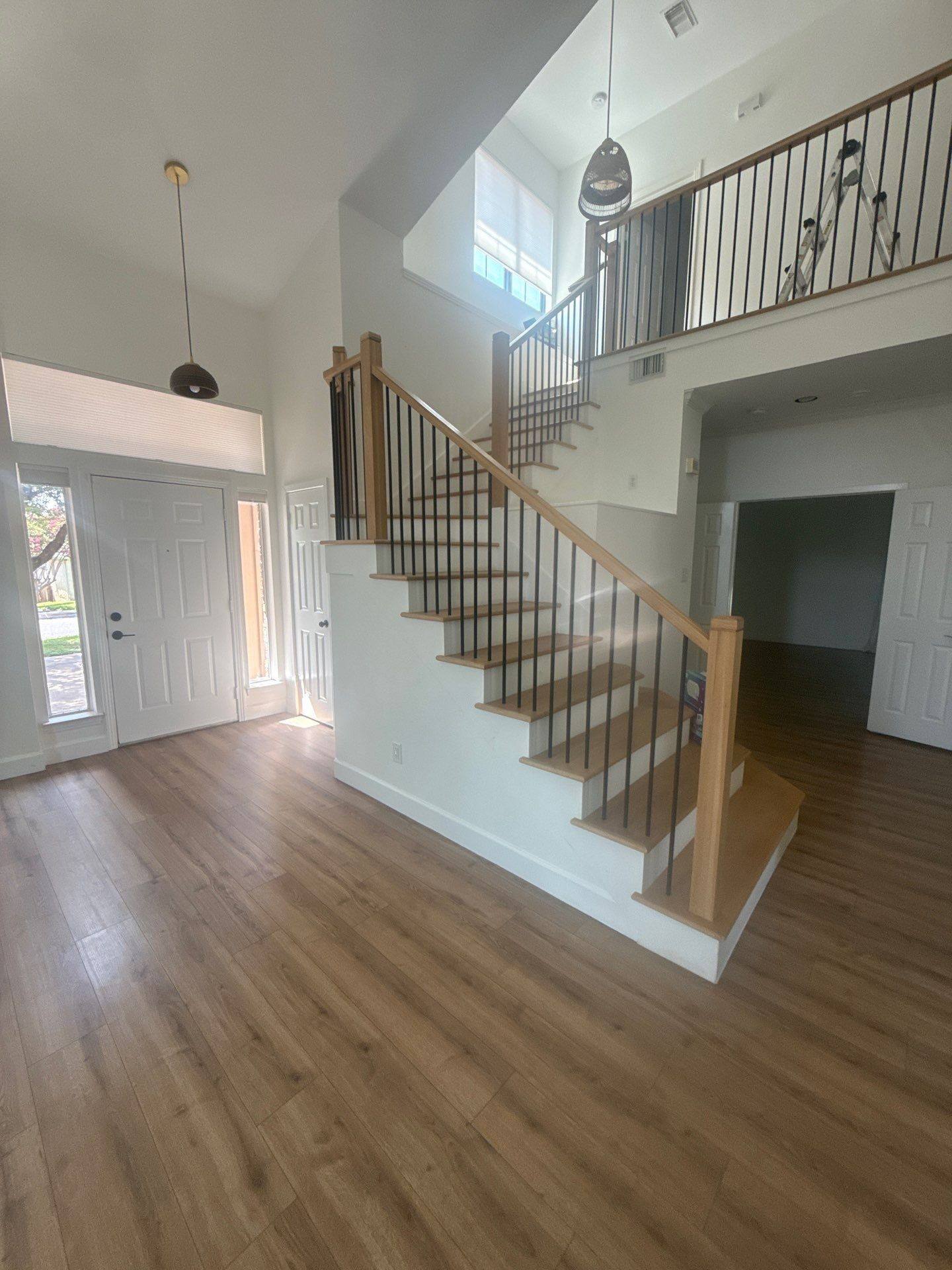Entryway and stairwell of a home on Poynette Pl in Austin, TX ahead of interior painting by Hill Country Painting