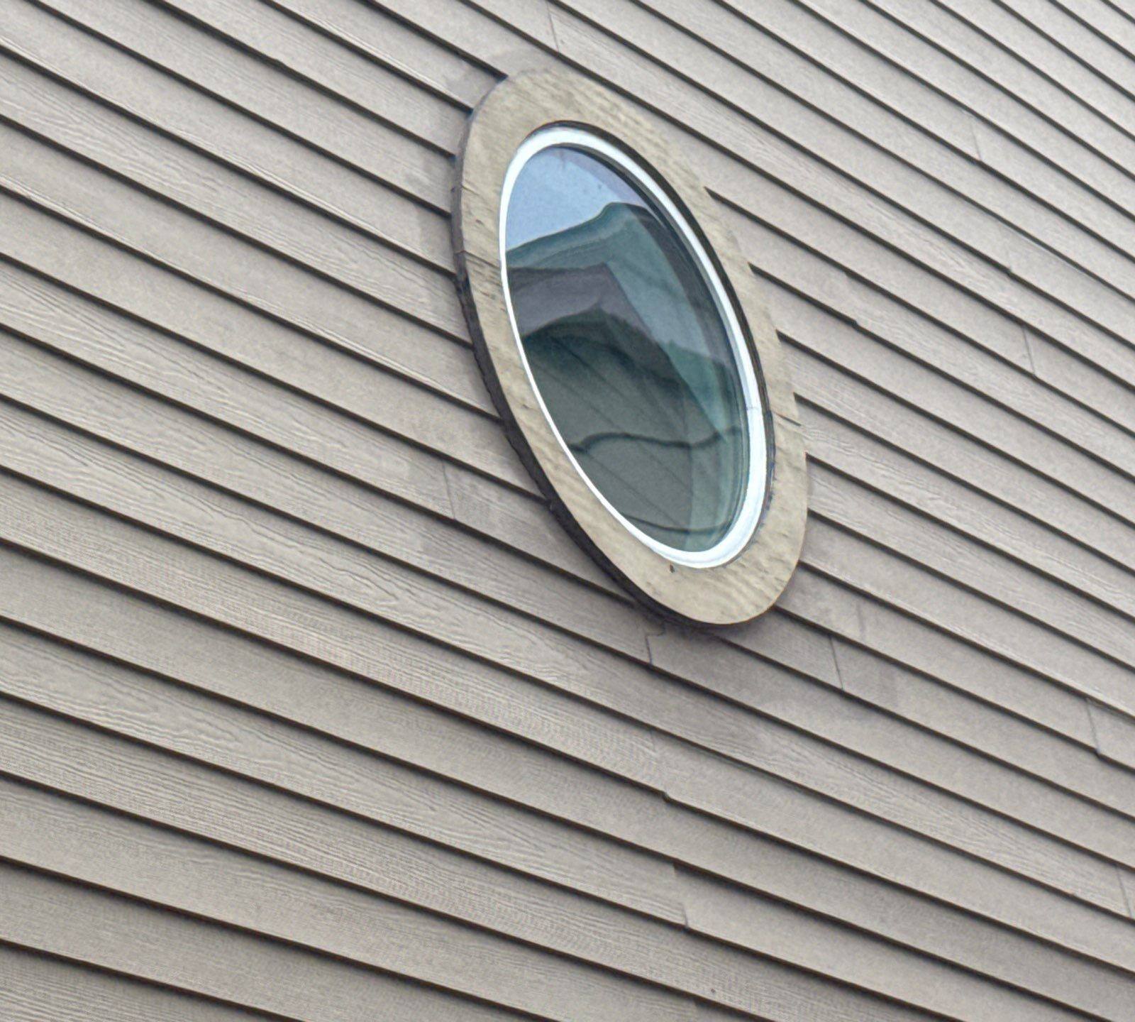 Round window detail on a home on Weatherwood Cove in Austin, TX ahead of exterior painting by Hill Country Painting