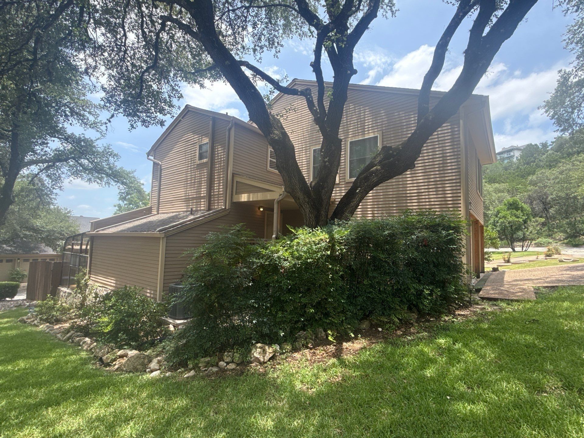 Exterior siding of a home on Weatherwood Cove in Austin, TX ahead of exterior painting by Hill Country Painting