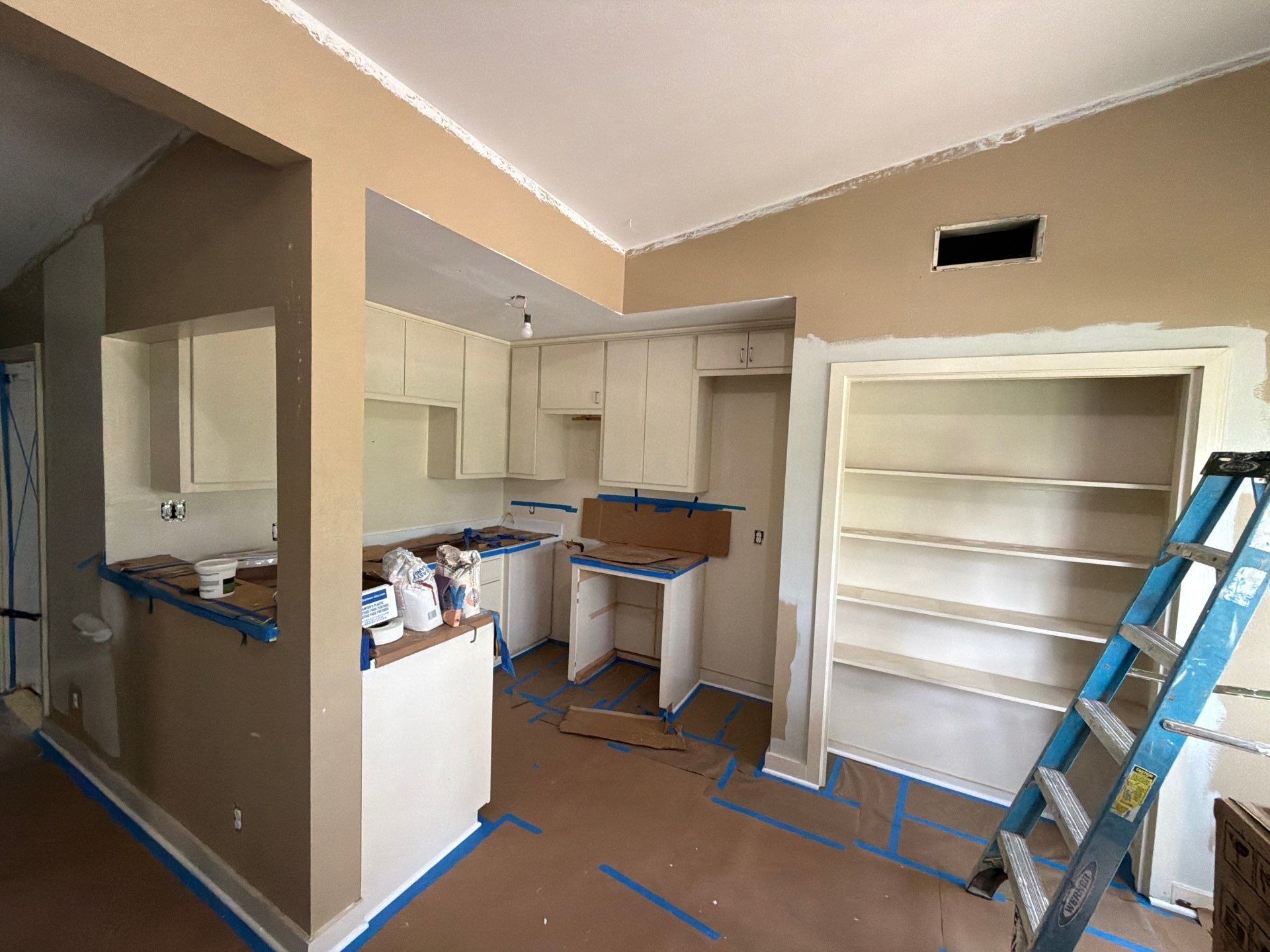 Kitchen preparation and painting in progress at a home on St Stephens Dr in Austin, TX by Hill Country Painting