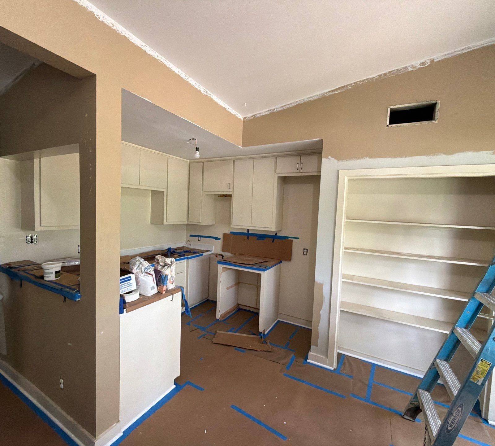 Kitchen preparation and painting in progress at a home on St Stephens Dr in Austin, TX by Hill Country Painting