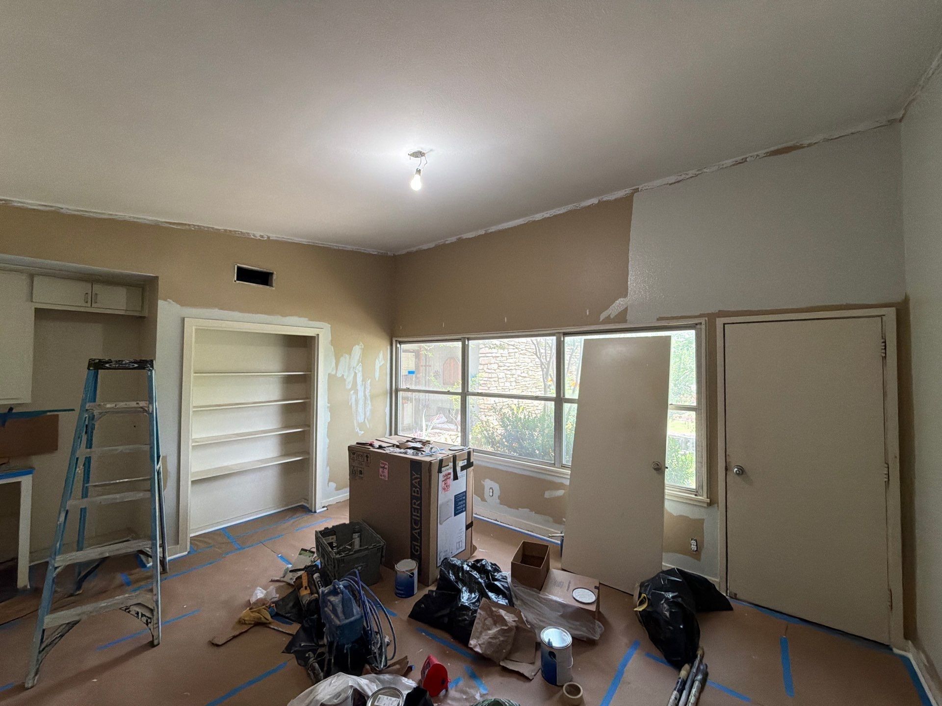 Interior room preparation and painting in progress at a home on St Stephens Dr in Austin, TX by Hill Country Painting
