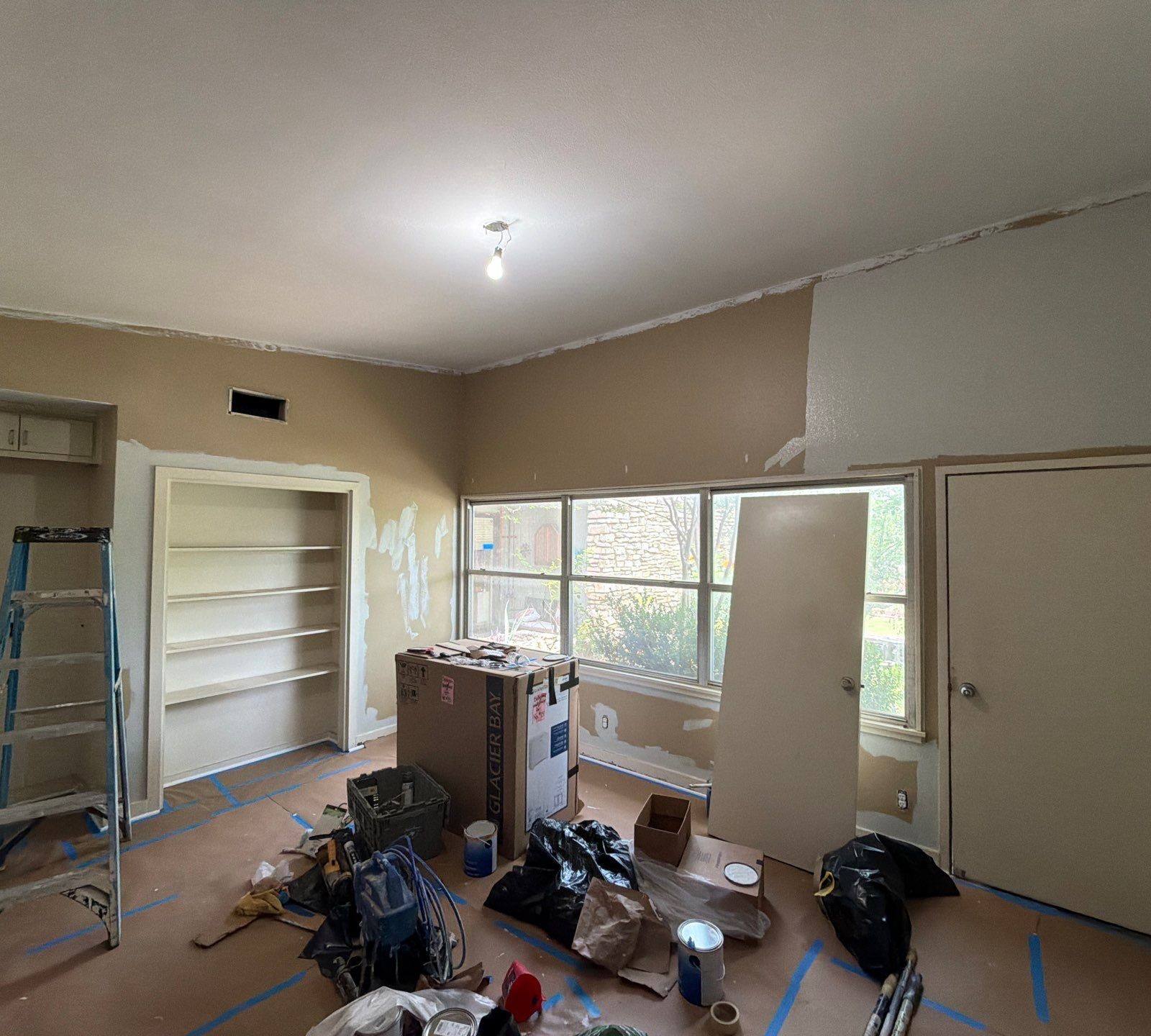 Interior room preparation and painting in progress at a home on St Stephens Dr in Austin, TX by Hill Country Painting