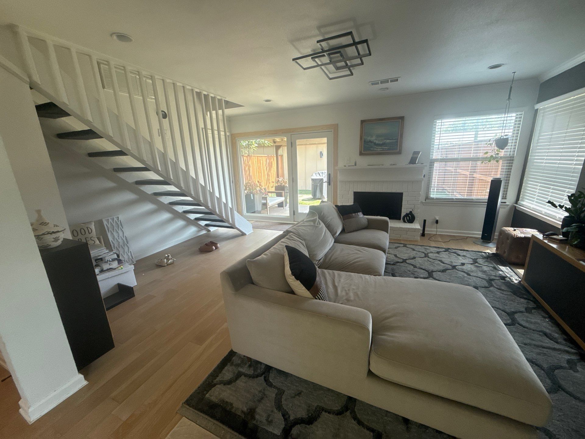 Living room and stairwell in a home on W Braker Ln in Austin, TX ahead of interior painting by Hill Country Painting