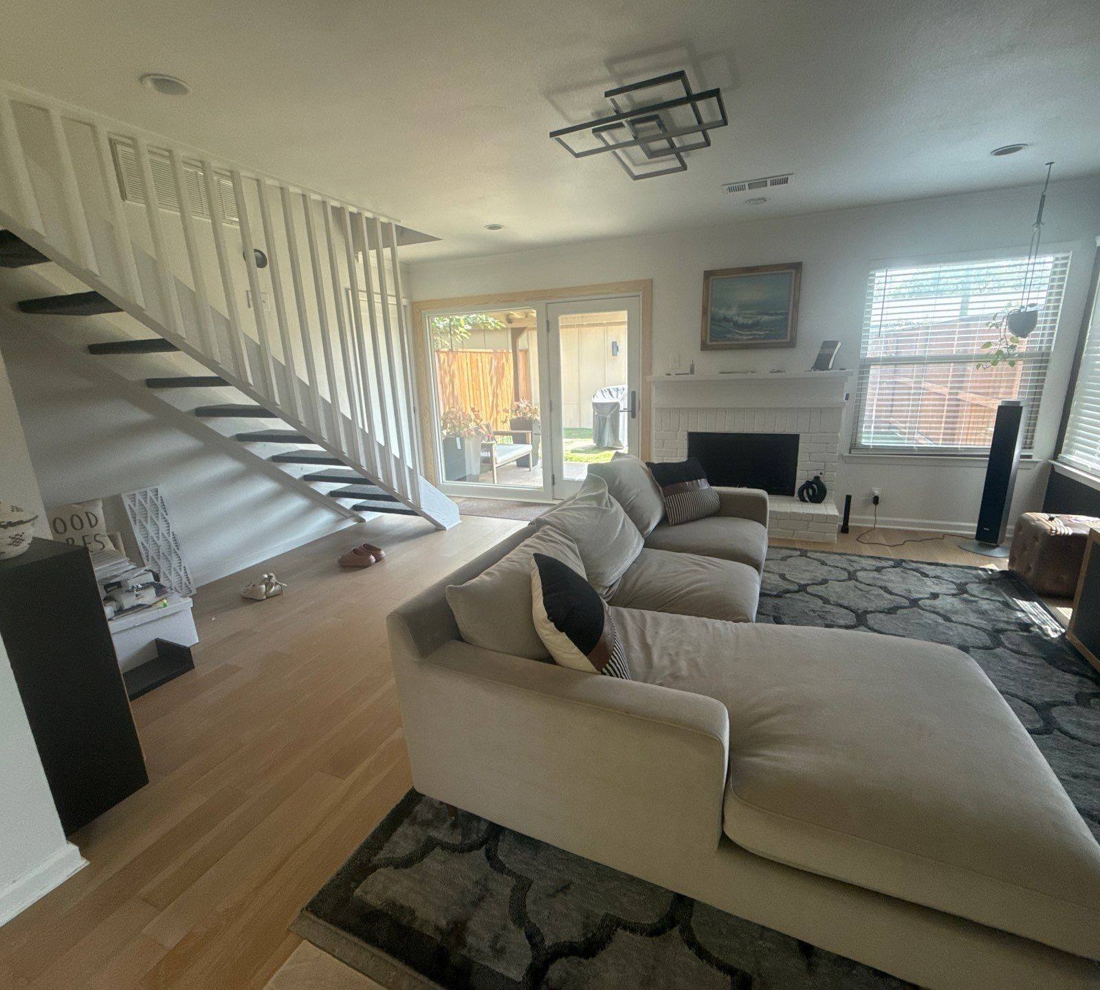 Living room and stairwell in a home on W Braker Ln in Austin, TX ahead of interior painting by Hill Country Painting