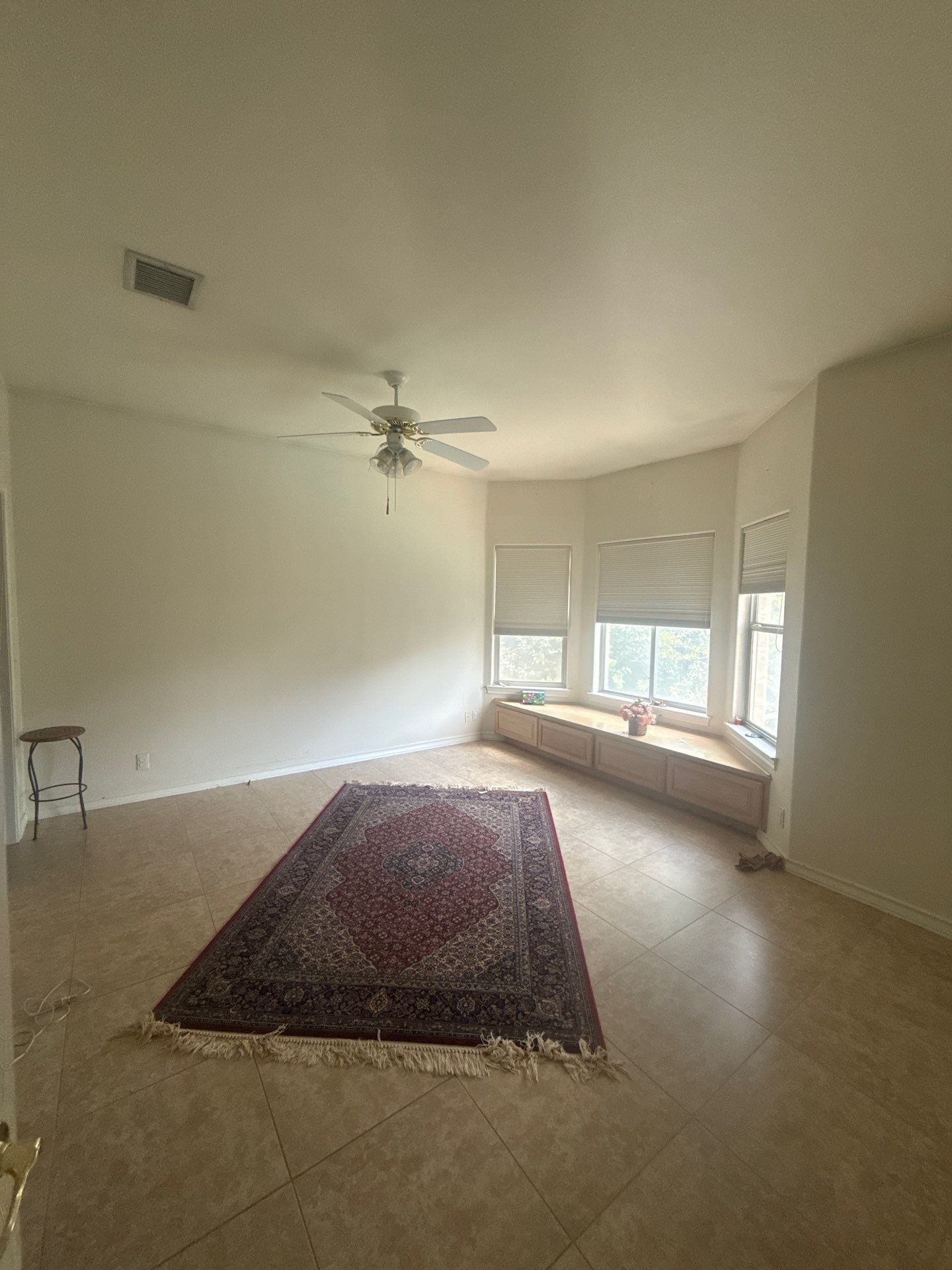 Upstairs bedroom with bay window seating area in a home on Winnipeg Cove in Austin, TX ahead of interior painting by Hill Country Painting
