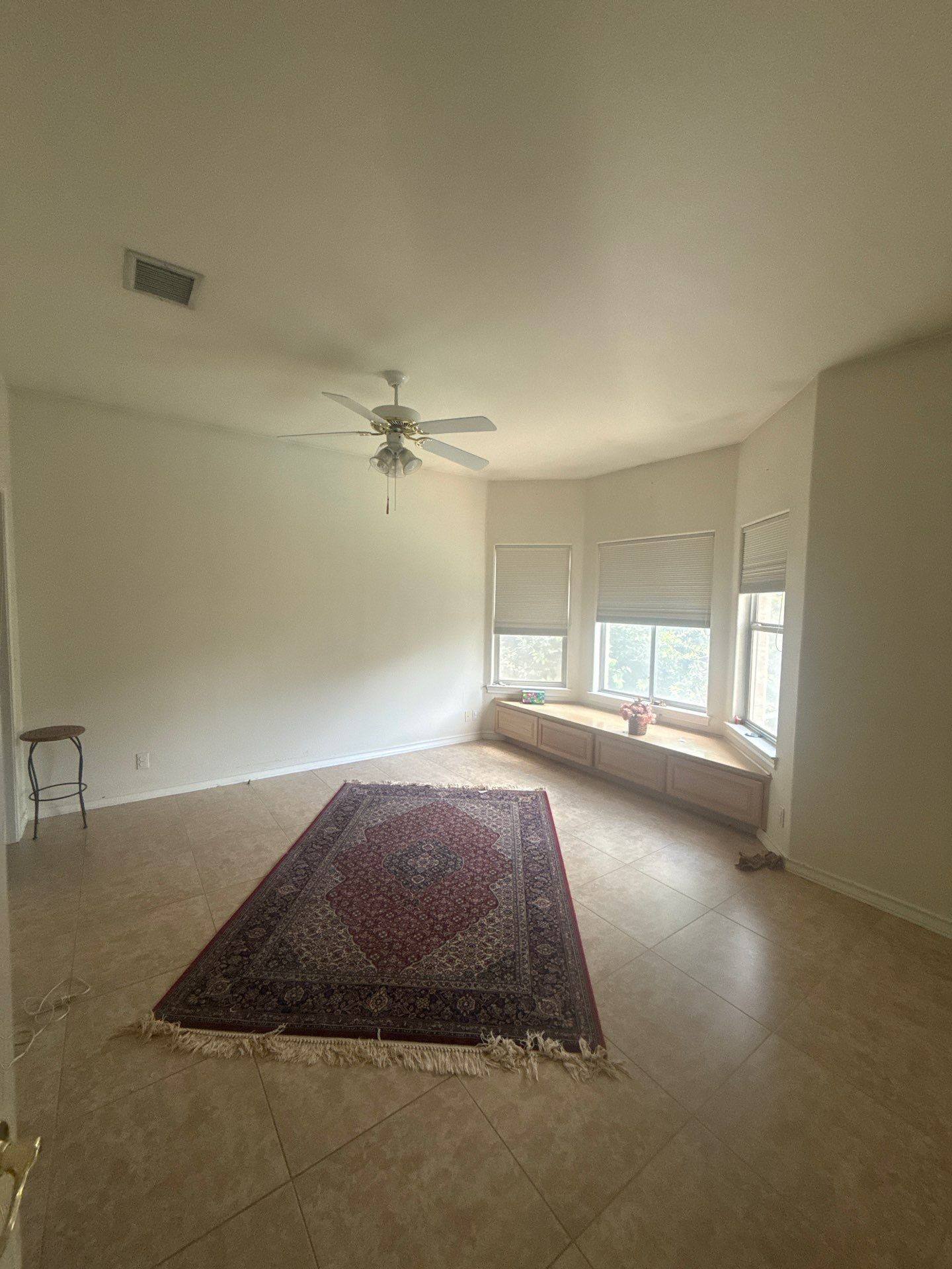 Upstairs bedroom with bay window seating area in a home on Winnipeg Cove in Austin, TX ahead of interior painting by Hill Country Painting