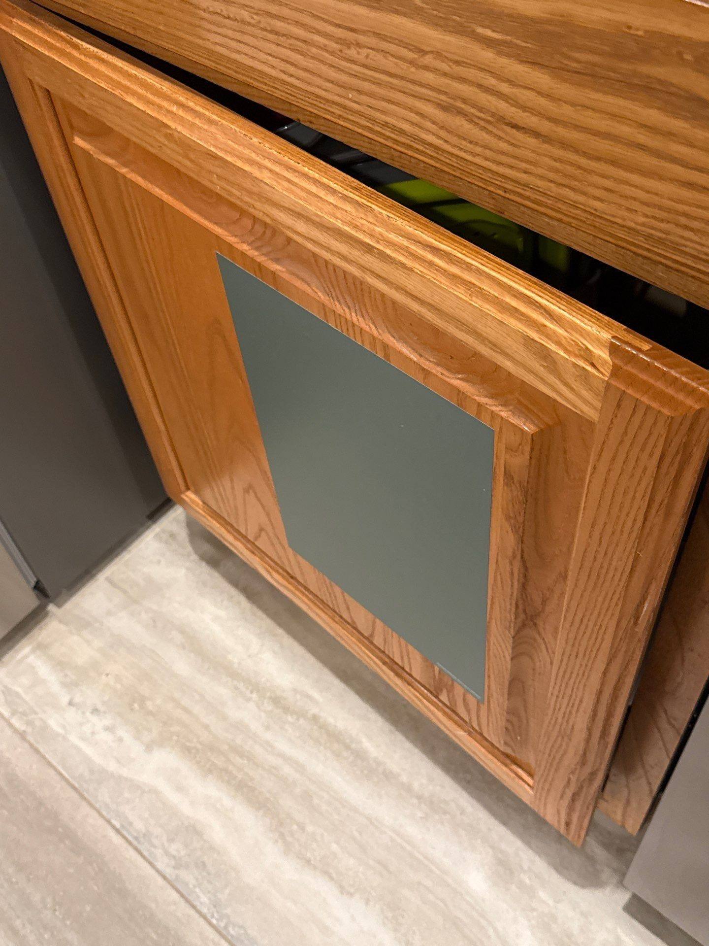 Cabinet door with paint color sample in a home on Spindletop Ter in Round Rock, TX ahead of cabinet refinishing by Hill Country Painting