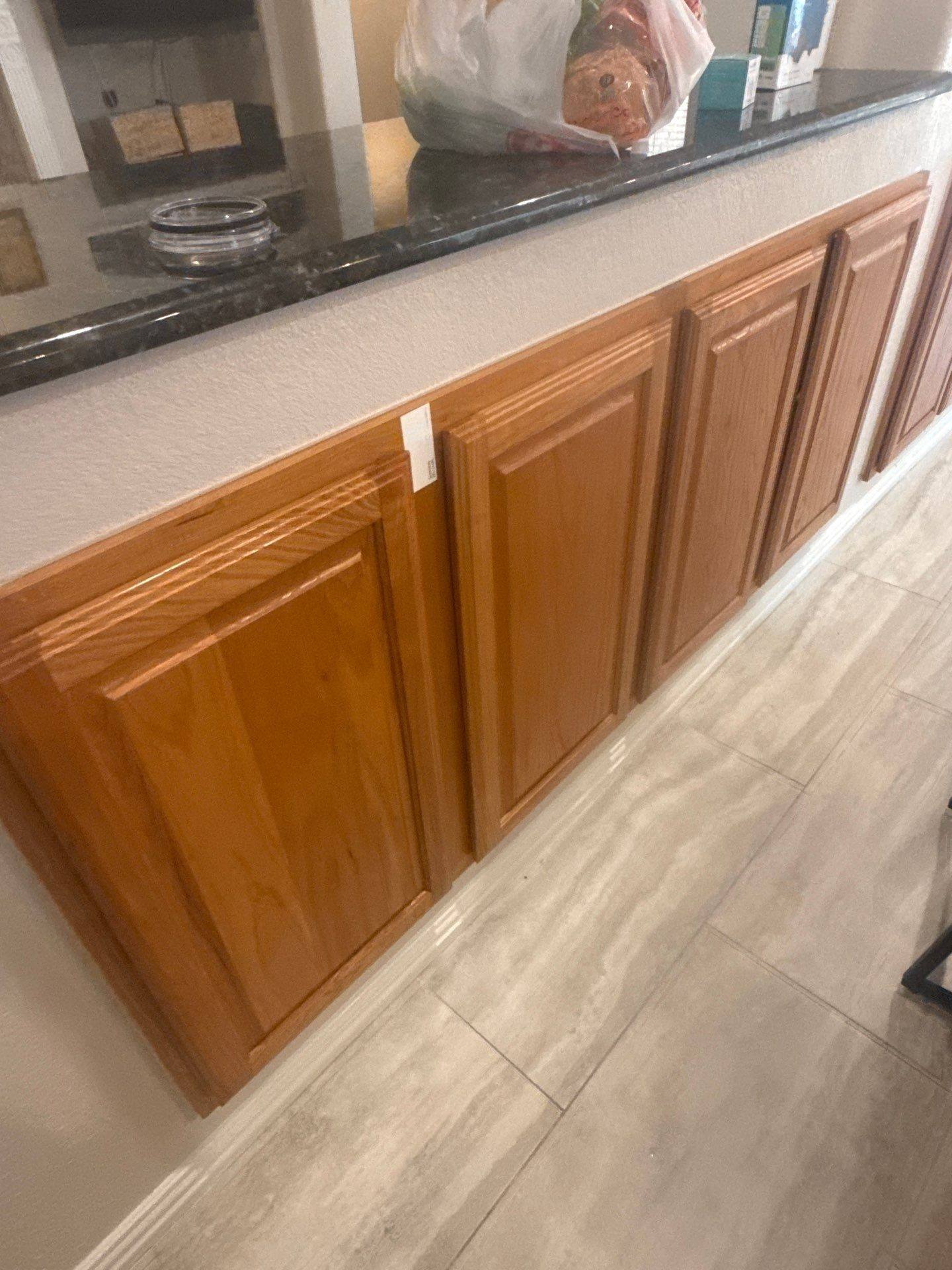 Kitchen cabinets in a home on Spindletop Ter in Round Rock, TX ahead of cabinet refinishing by Hill Country Painting