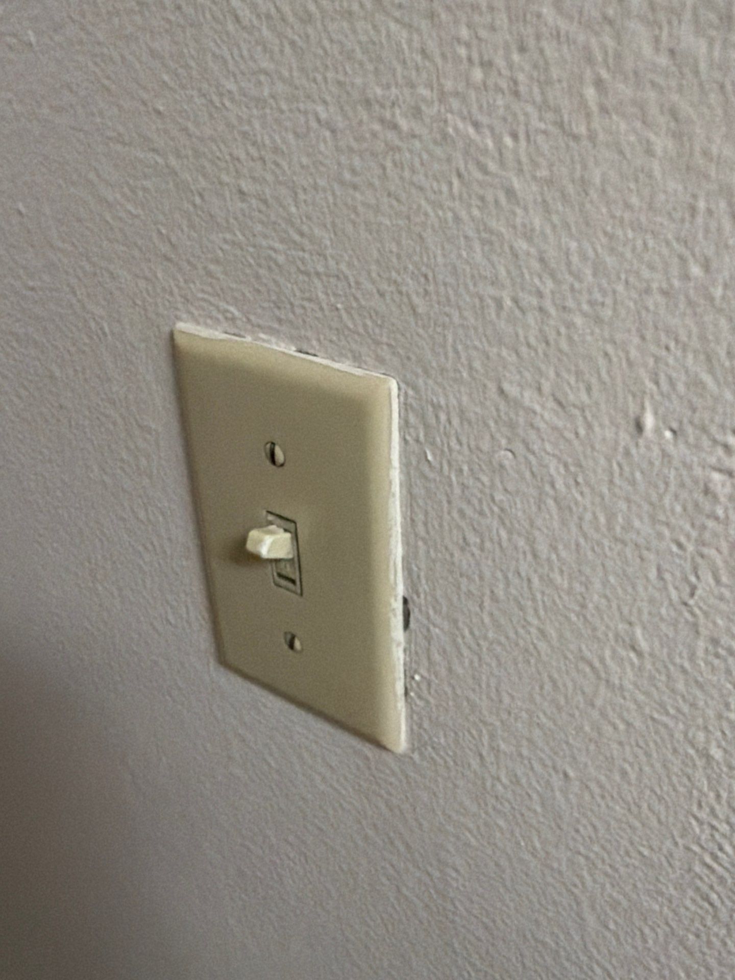 Wall switch cover at a property on St Stephens Dr in Austin, TX ahead of interior trim and outlet painting by Hill Country Painting