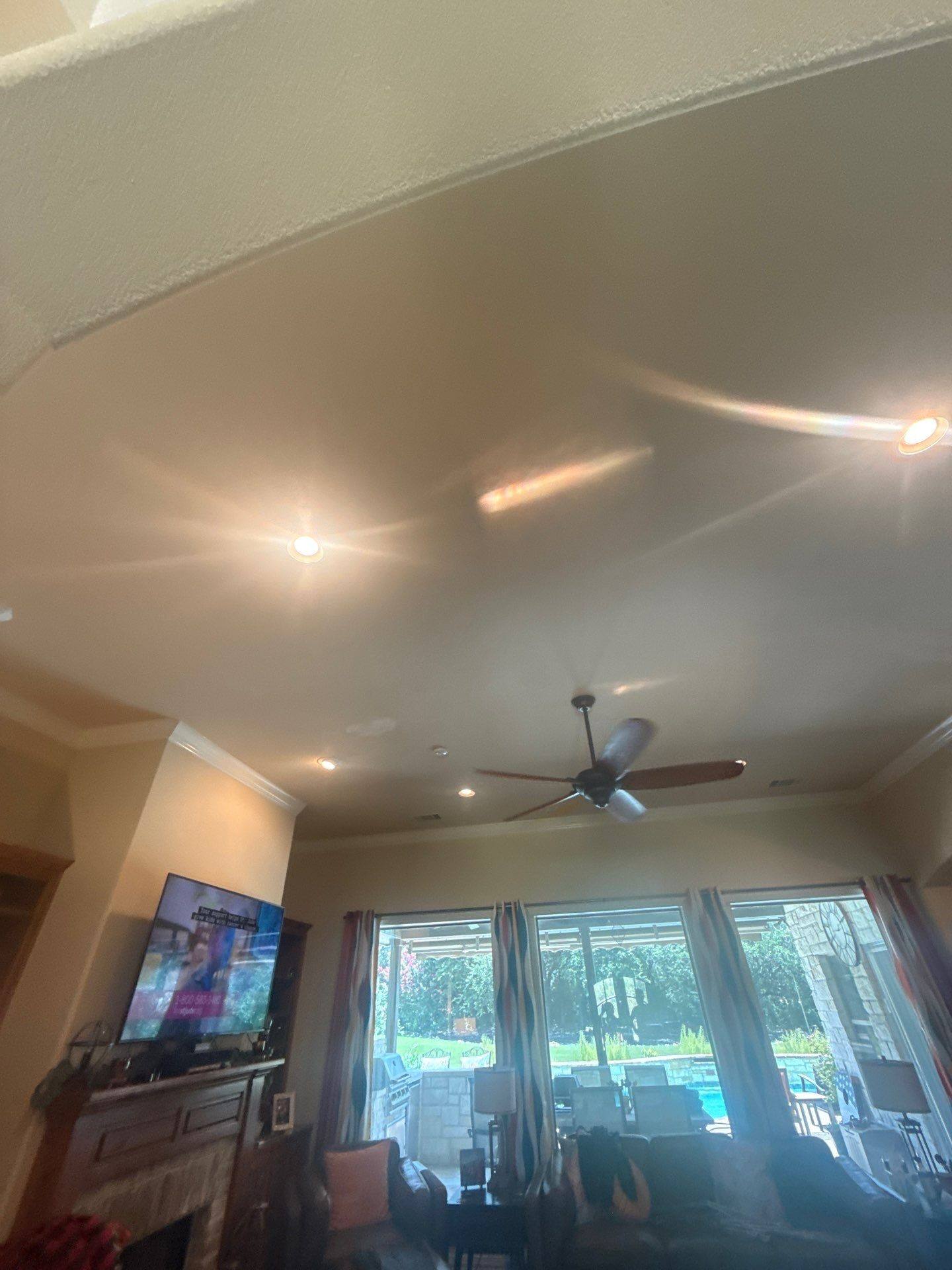 Vaulted living room ceiling with ceiling fan at a property on Tanksley Cir in Georgetown, TX ahead of interior ceiling painting by Hill Country Painting