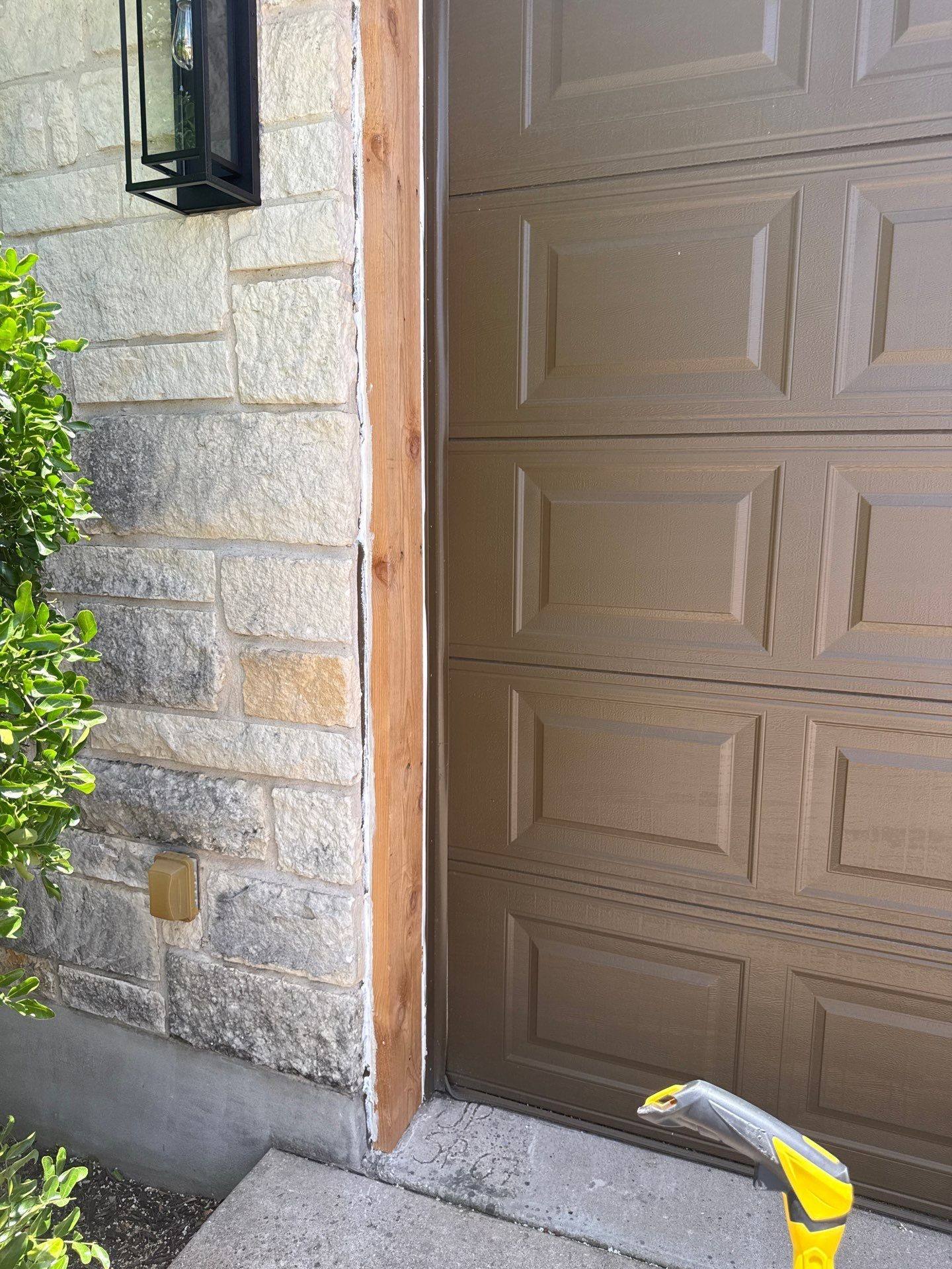 Vertical trim beside the garage door at a property on Tanksley Cir in Georgetown, TX ahead of exterior trim painting by Hill Country Painting