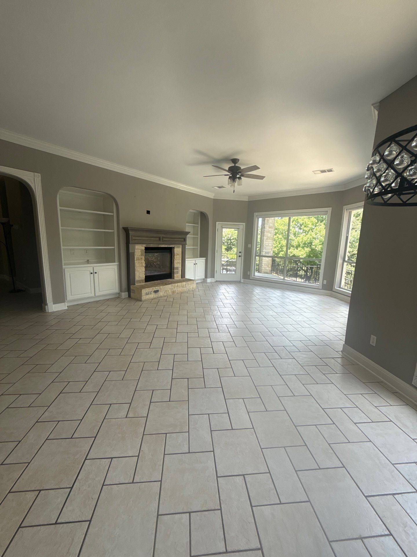 Living room with fireplace mantle and built-in shelving at a property on Mira Mesa Dr in Austin, TX ahead of interior painting by Hill Country Painting