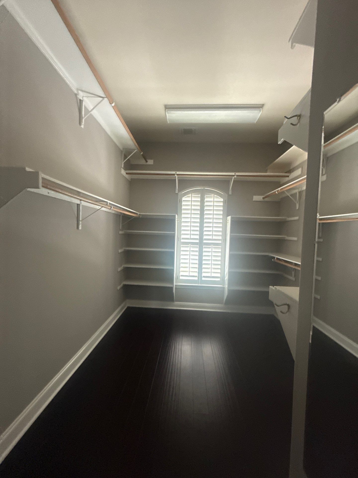 Walk-in closet with built-in shelving at a property on Mira Mesa Dr in Austin, TX ahead of interior painting by Hill Country Painting
