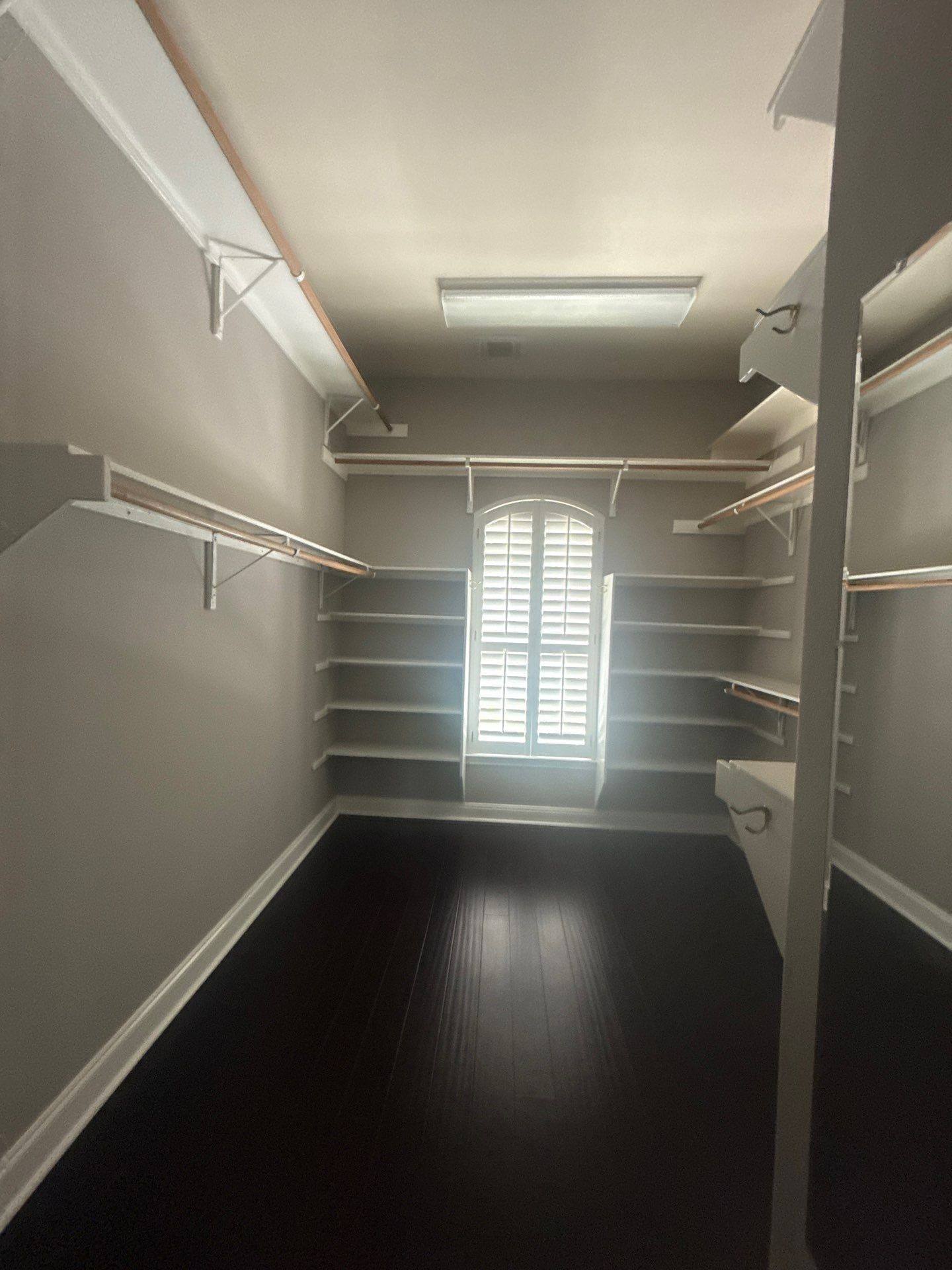 Walk-in closet with built-in shelving at a property on Mira Mesa Dr in Austin, TX ahead of interior painting by Hill Country Painting