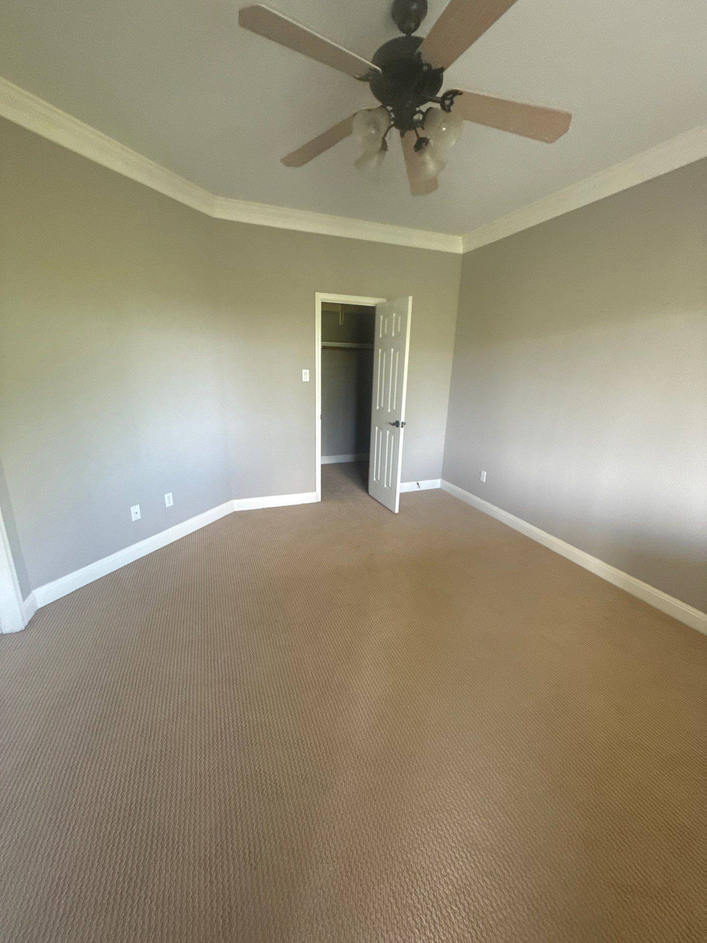 Bedroom with carpet and closet at a property on Mira Mesa Dr in Austin, TX ahead of interior painting by Hill Country Painting