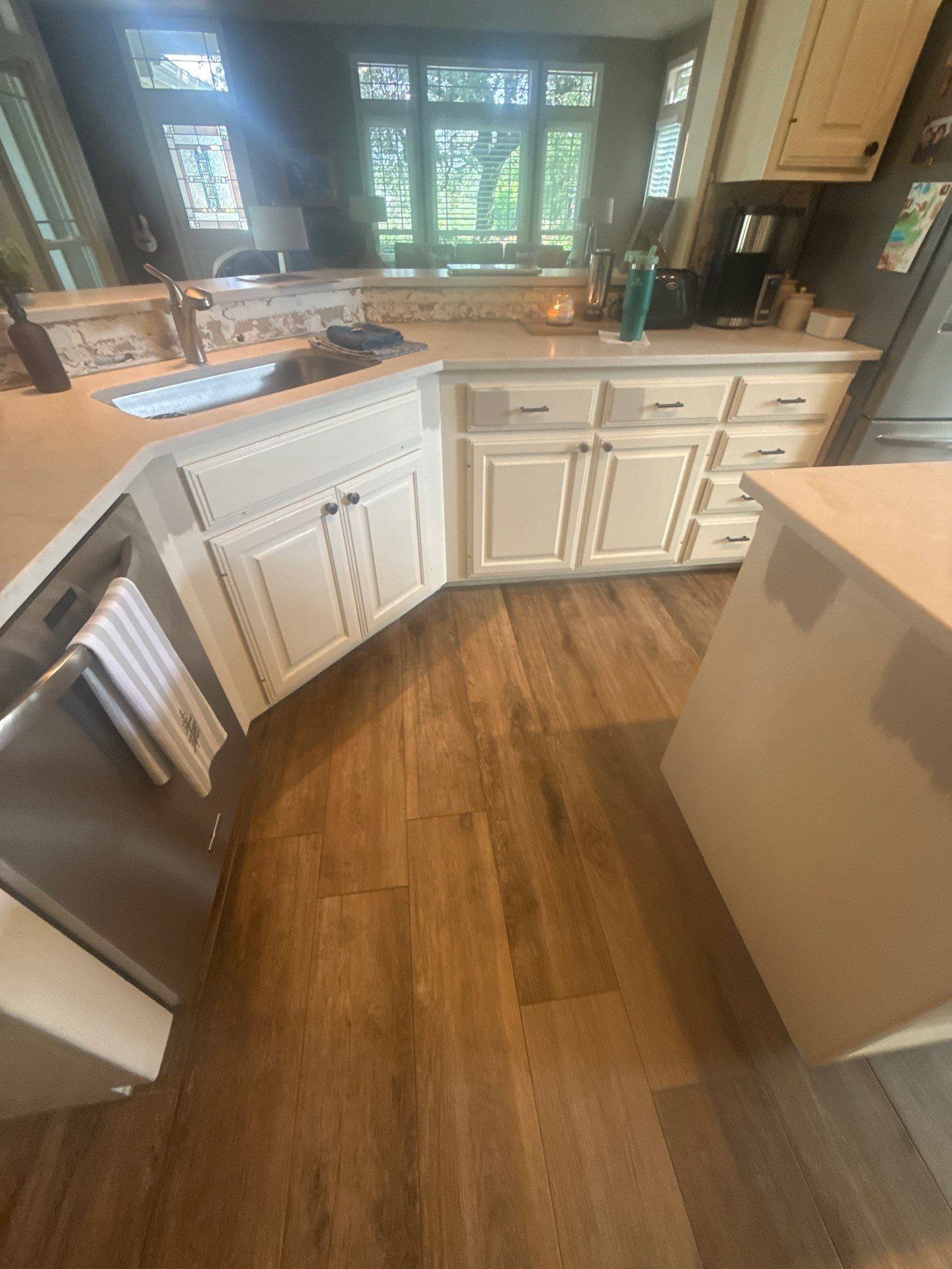 Kitchen with white cabinetry and countertops at a property on Nautilus Ave in Lakeway, TX ahead of interior painting by Hill Country Painting