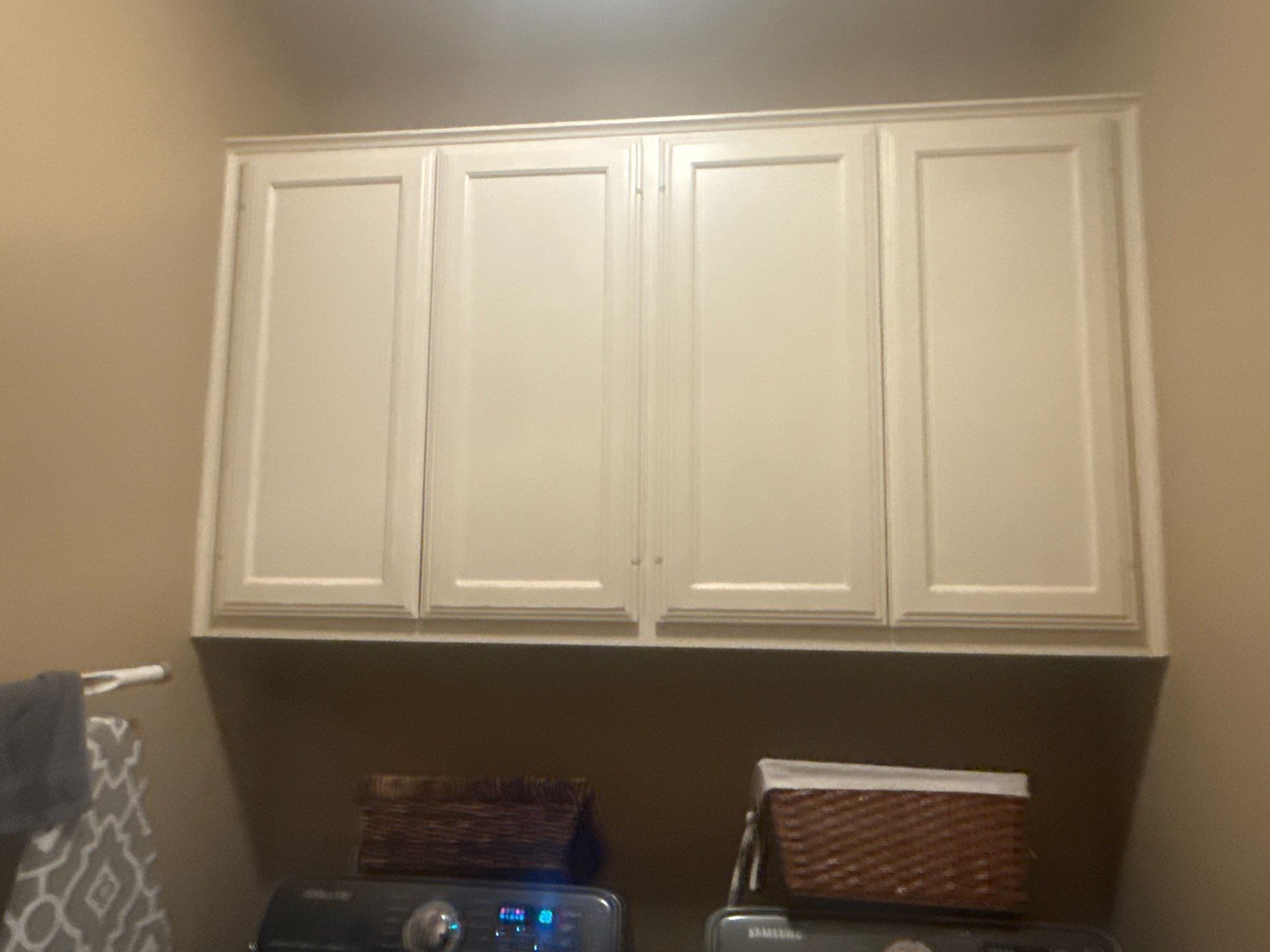 Laundry room cabinetry at a property on Nautilus Ave in Lakeway, TX ahead of interior painting by Hill Country Painting