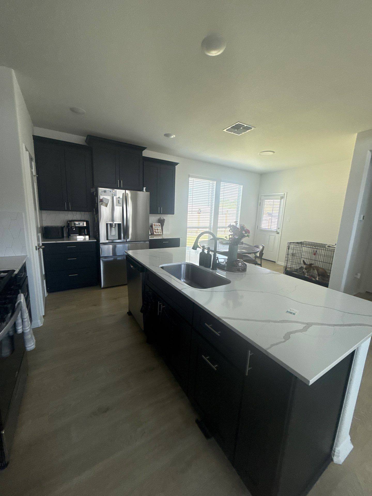 Kitchen and dining area at a property on Halas St in Manchaca, TX ahead of interior painting by Hill Country Painting