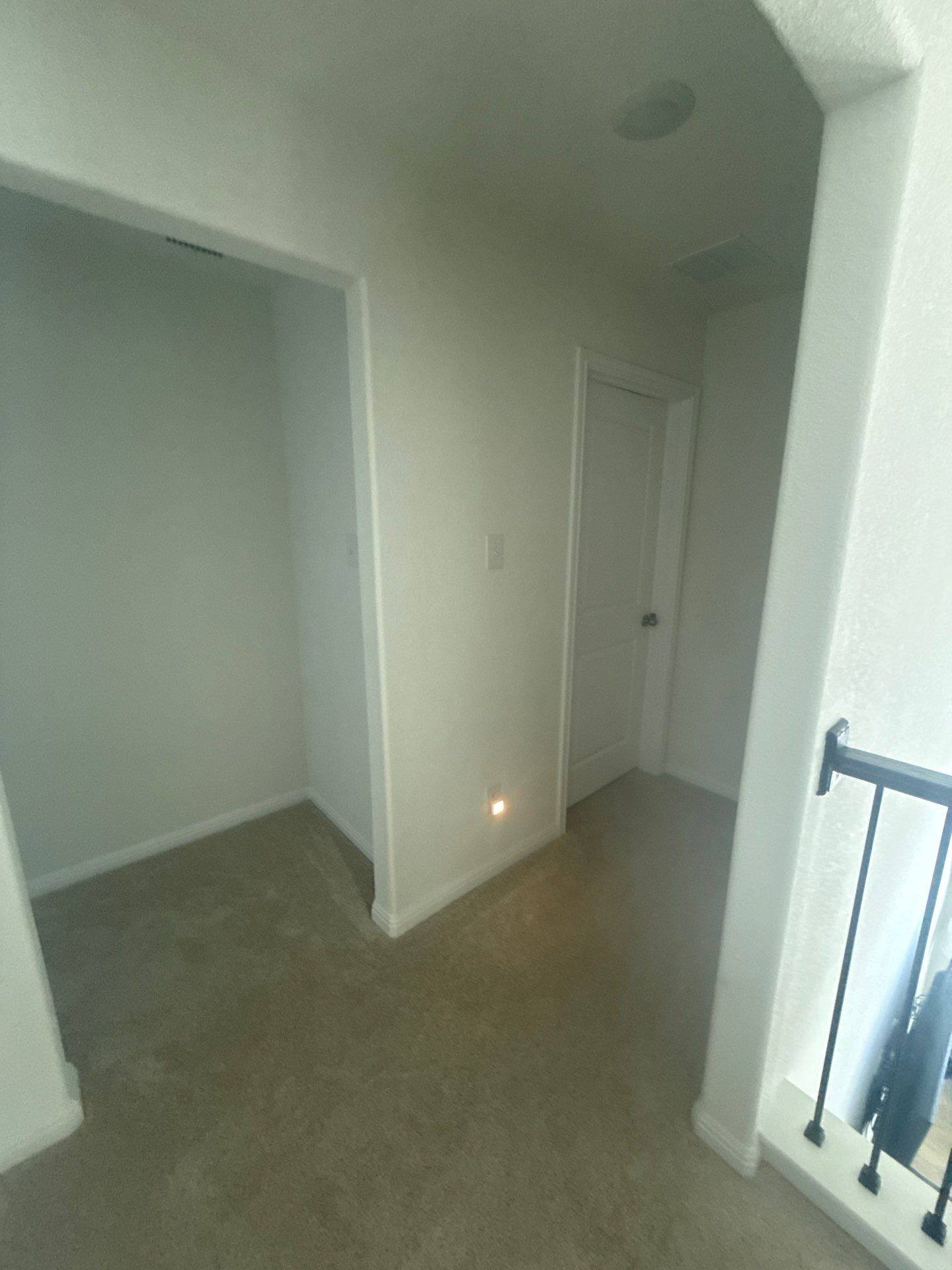 Hallway at a property on Halas St in Manchaca, TX ahead of interior painting by Hill Country Painting