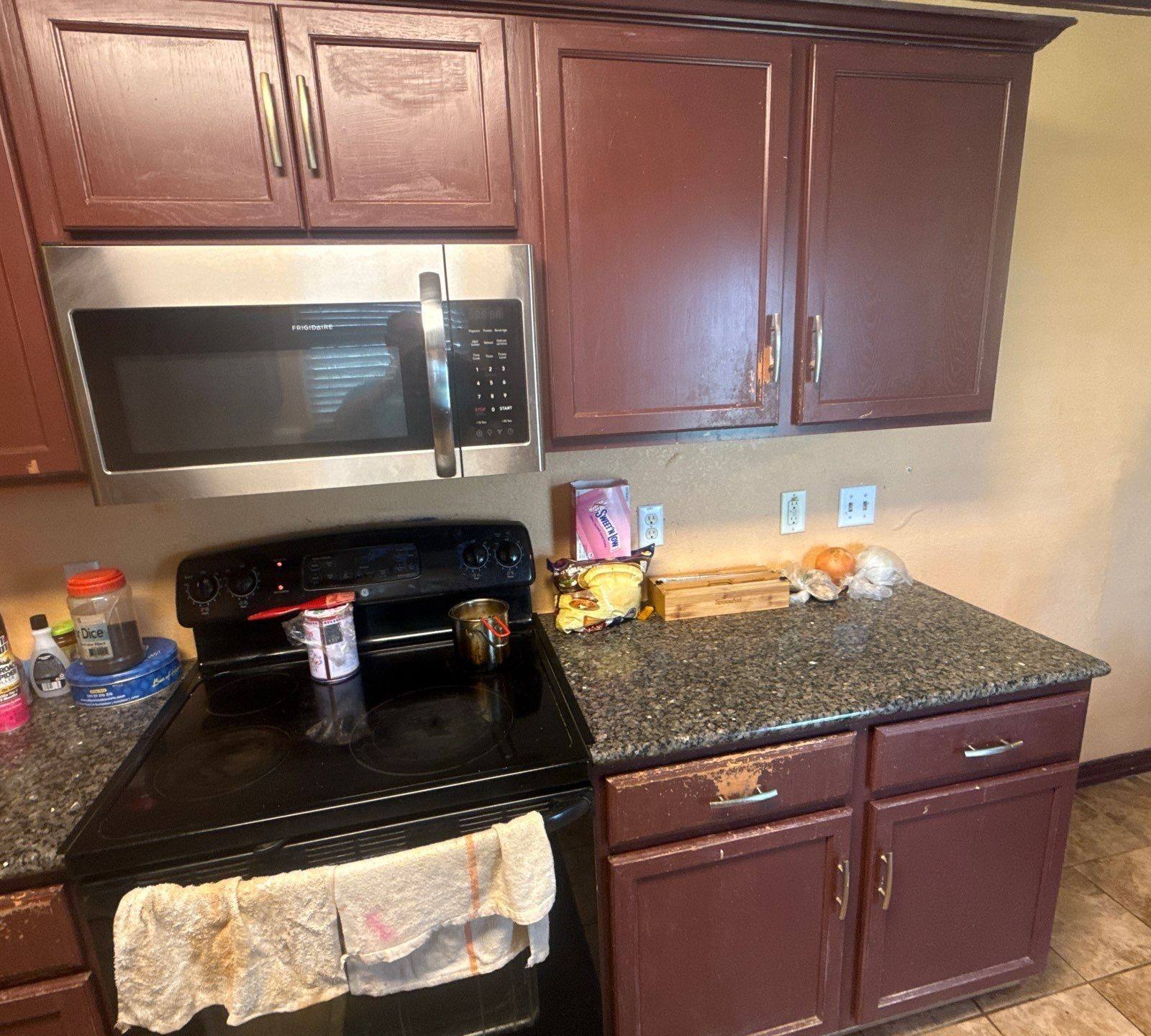 Kitchen cabinets at a property on Pine Needle St in Manor, TX ahead of cabinet refinishing by Hill Country Painting