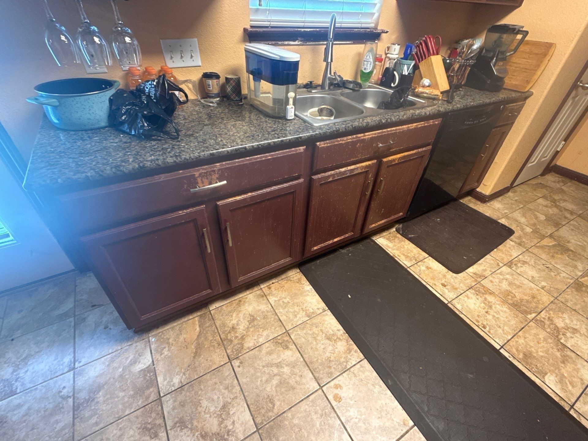 Kitchen cabinets at a property on Pine Needle St in Manor, TX ahead of cabinet refinishing by Hill Country Painting