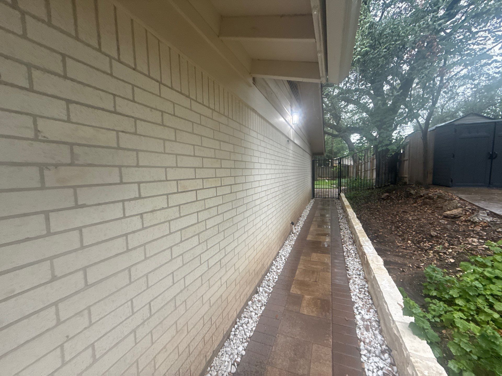 Side exterior walkway and soffit of the home ahead of painting