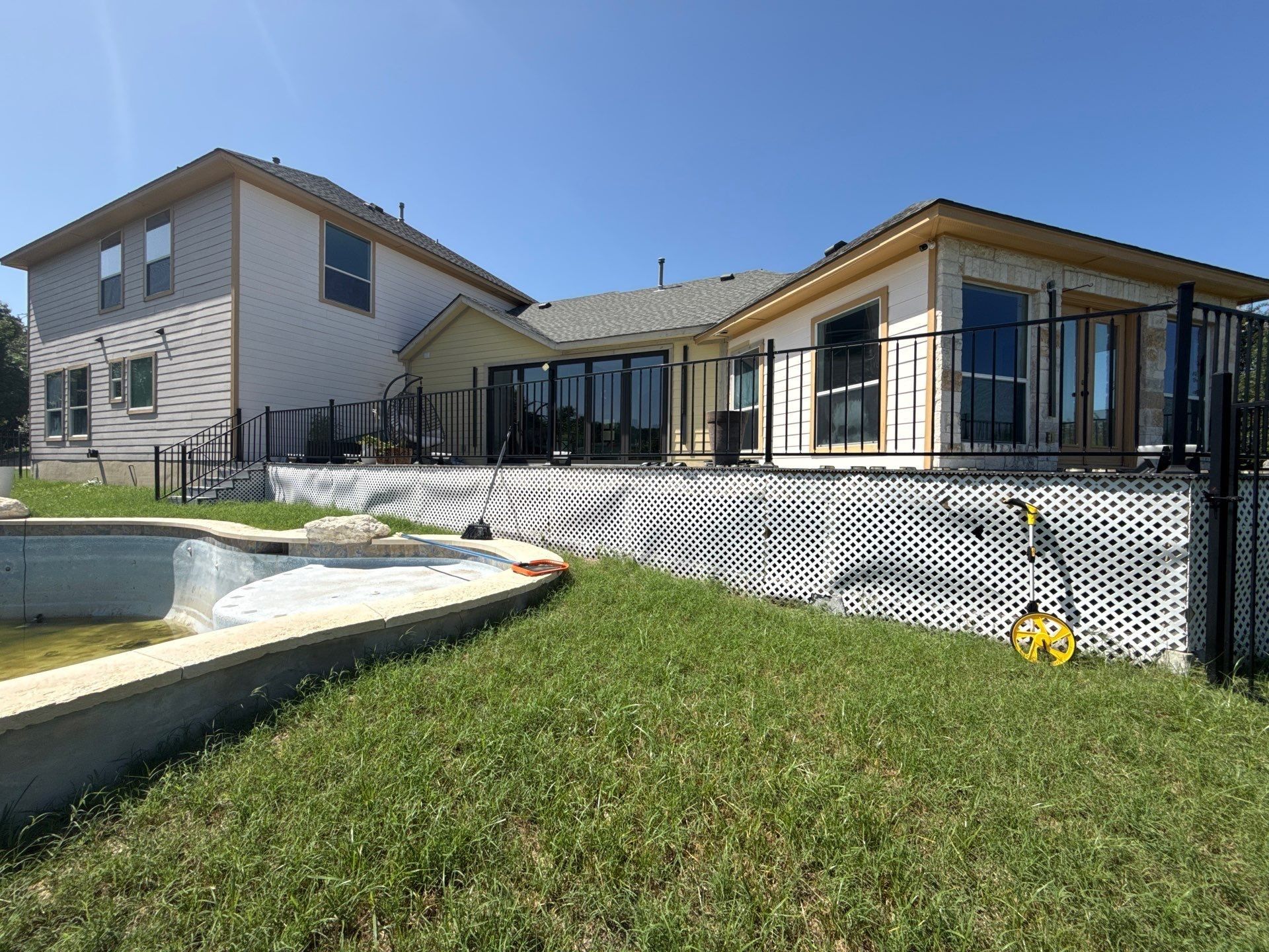 Back exterior of the home with pool ahead of painting
