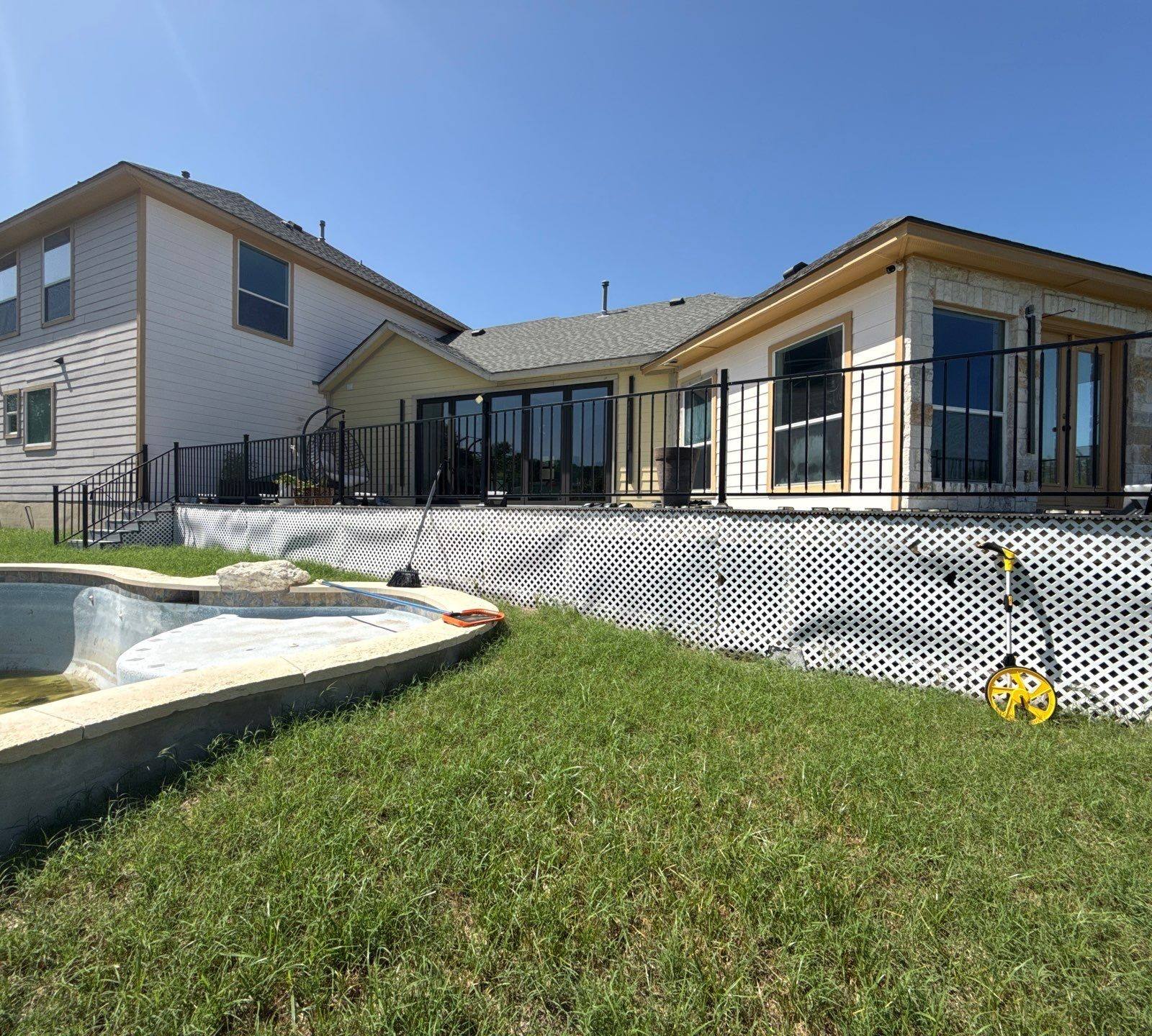 Back exterior of the home with pool ahead of painting