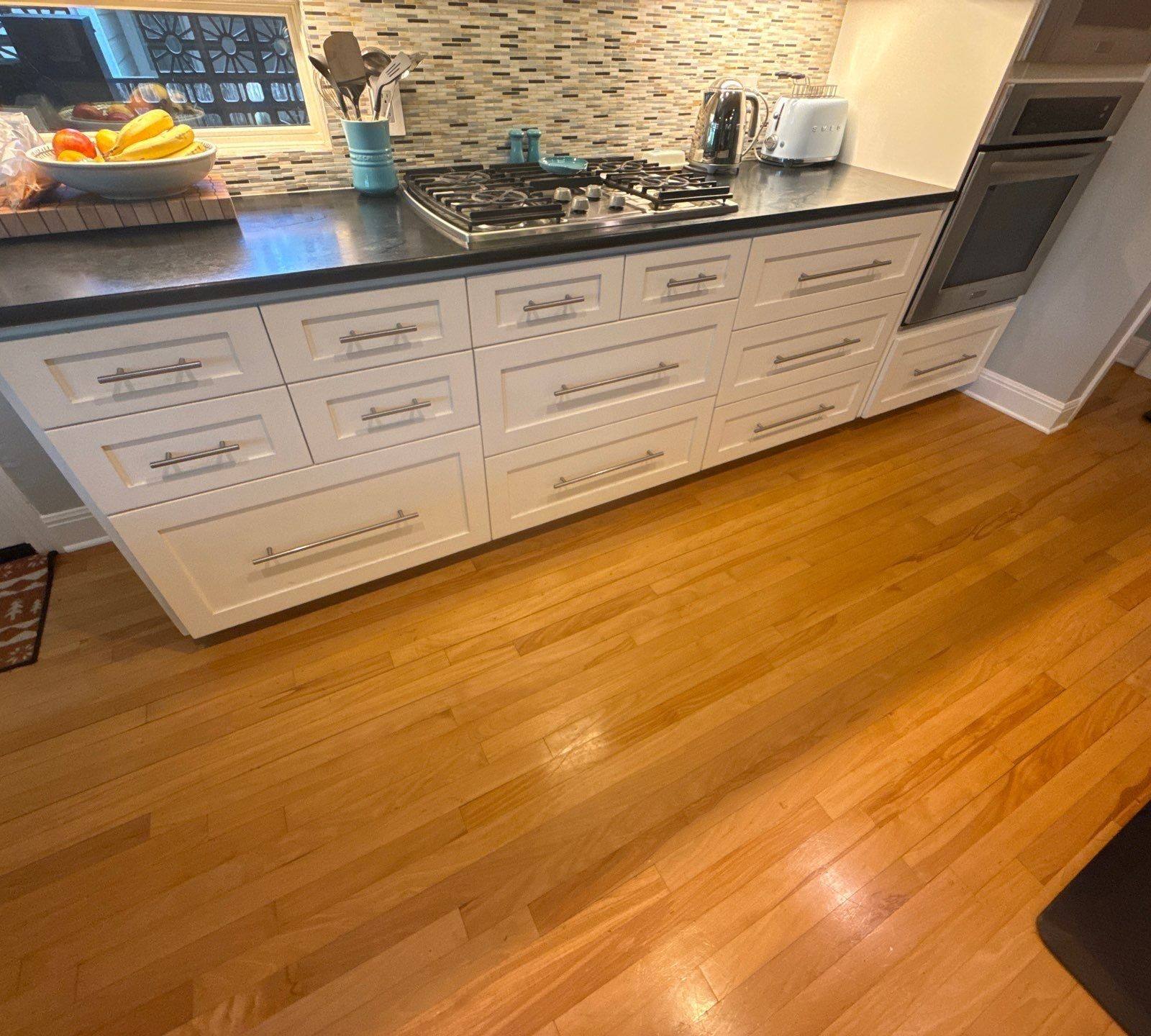 Row of kitchen cabinet drawers and appliances ahead of painting