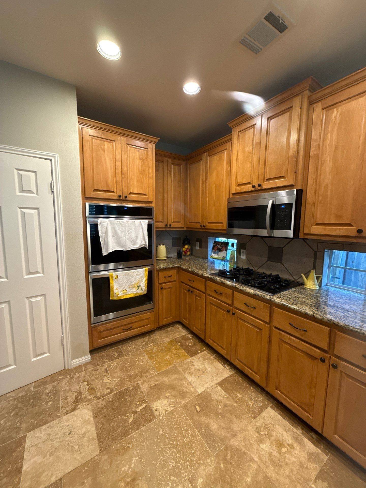 Kitchen cabinets, double ovens, and microwave ahead of painting